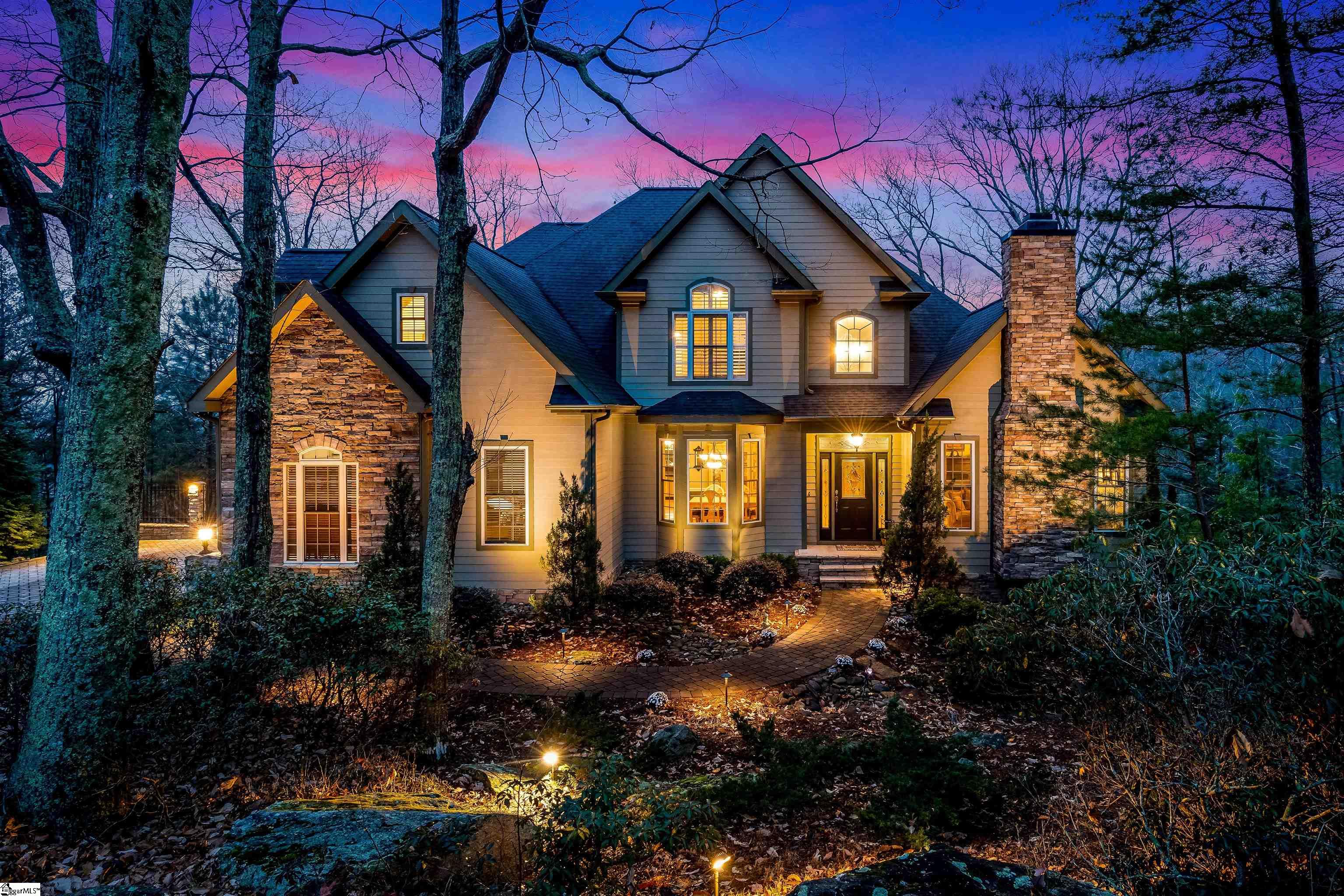 This mountain-top custom-built beauty sits nestled in the prestigious community of The Cliffs at Glassy on 2.51 acres with a creek in the back! Why wait to build when you can have this one and personalize to your own style? This home is 2 stories PLUS a FULL FINISHED BASEMENT that has ability to serve as a full second living quarters. 7 total bedrooms, 4.5 bathrooms, 3 fireplaces, expansive decks, hardwood flooring, open concept living, and wine cellar. On the main floor, you have the Master Suite as well as another secondary bedroom with full bathroom attached. Also on the main floor is a walk-in laundry room, half bath, formal dining room, front room with it's own fireplace that can serve as the perfect flex space for a home office, formal sitting room, or library. There is also the main living room with another fireplace, breakfast room, and kitchen. Off the kitchen is the top deck which gives you partial mountain views in the winter months, and a secluded oasis in the summer. Upstairs you have 3 oversized bedrooms, one full bath with dual vanities, and a large loft area. One of the bedrooms upstairs is large enough to serve as a bunk room, playroom, or bonus/rec/hobby room. There are spacious closets as well as walk in attic spaces off the largest bedroom and the loft area. In the basement you have a second full kitchen, living room with another fireplace, pantry, full bath, rec room, heated/cooled large storage room, wine cellar, 2 large bedrooms with big closets, and even under stairs storage. The basement also has access to a second back deck. This is the perfect space to entertain for big family holidays, allow the in-laws or teens to have their own space, or watch the big games in style! The curb appeal on this home is absolute perfection and the home has been meticulously maintained. Enjoy beautiful landscape/up lighting, paver patio, aluminum fencing at the back of driveway, and a side entry garage. *Furniture in the home is negotiable on a separate bill of sale.* This makes it for the perfect move in-ready and furnished home! Enjoy all the luxuries of The Cliffs; golf, tennis, pool, and the infamous Glassy Chapel. It is truly breathtaking so make sure to pop up there to the chapel after your showing (as long as no events are going on) and have the camera ready! Schedule your showing today before this one slips away!