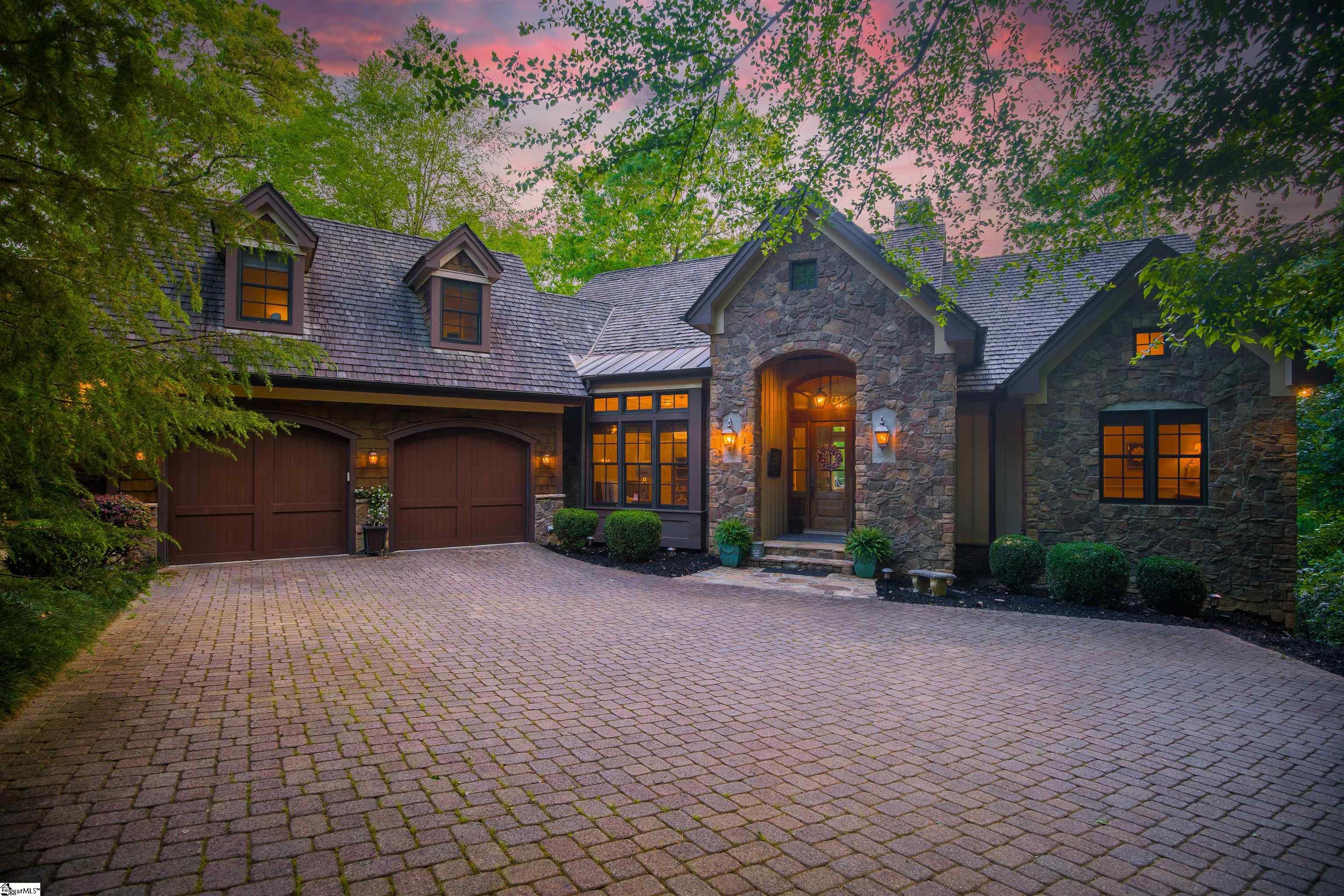 Casually Elegant. Originally constructed as a model home for esteemed Allora builders in 2007, 108 White Magnolia is dripping in custom, bespoke features from floor to ceiling! A few notable features that are immediately apparent upon arrival, is the beautiful stone exterior, copper accents, copper gutters and cedar shake roof.   Home is situated nicely on almost an acre (0.9 acre), allowing for privacy, a nice backyard (hard to find in the mountains!) and direct access to nature trails. Once inside, a large great room awaits with soaring coffered ceilings, a stacked stone fireplace and a wall of windows overlooking the natural mountainscape to the rear. Hickory floors run the throughout the main level. A beautiful kitchen and dining room overlook the living room. Kitchen offers Viking appliances, Sub Zero refrigerator, a breakfast bar, and island with vegetable sink. The adjacent screened porch has a very cozy treehouse vibe and is a popular hangout spot. If dining al fresco is more your speed, a large back deck can easily accommodate. Back inside on the main level you’ll find a gracious study (fourth bedroom or formal dining) just off the foyer with built ins, coffered ceiling and an adjacent full bath and bar. The master suite is a dream… offering a luxurious bath with jacuzzi tub, dual vanities and tile shower. Also offers direct access to the back deck.   Find your way downstairs to find a lower den/rec room that is ready to host your next movie night. Two guest bedrooms with en suite baths can be found on either side of the lower den. A back terrace offers a third outdoor living space.   A private suite can be found over the garage. Whether you need a game/craft room, man cave or private bedroom suite, that will truly fit the bill.   Do you enjoy natural amenities like hiking trails, rivers and lakes? Or perhaps manicured, man made amenities are more your speed? At 108 White Magnolia, you don’t have to choose. The property borders a 272 acre county park to the east with hiking and mountain biking trails, a fishing lake and a waterfall and streams. Within the Cliffs at Mountain Park, members are treated to world class amenities like a Gary Player Golf Course, Wellness Center, and the Cabin.. a fan favorite restaurant. Mountain Park is centrally located amongst the Mountain and Lake regions, offering members access to all 7 Cliffs Clubs. A Cliffs Membership is available for purchase with this property. Located 35 minutes to downtown Greenville, 45 minutes to Asheville, 10 Minutes to Traveler’s Rest and 5 minutes from neighboring Cliffs Valley.   Building a home of comparable quality in Mountain Park today, would cost $1,375,000.