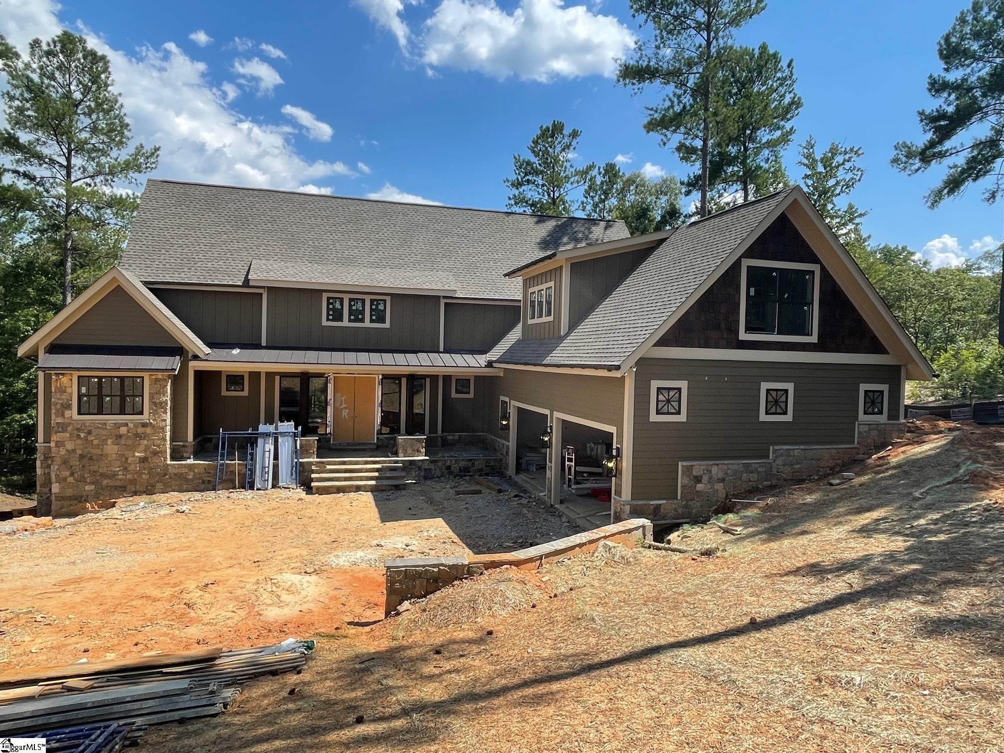 New construction waterfront home in the North Point section of the Cliffs at Keowee Falls. This 4 bedroom home plus bonus room features an open floor plan for entertainment and a highly functional design on the main level including a large master suite, large coffered ceiling great room for dining and casual living opening to a covered deck, open kitchen with large walk in pantry, and large laundry/mudroom.  With a walkout terrace level below you will find an additional guest suite, large entertainment area with wet bar, and a large lake toys storage room.  Upstairs you will find a very generous bonus room (options: office, exercise room, bunk room) above the oversized garage plus 2 additional guest suites with lake view.  Offering nice views of the lake, a dock to be placed on this .68 acre lot, a generous landscape package, a home automation package and many other features, this new home is a rare offering in the Cliffs communities.