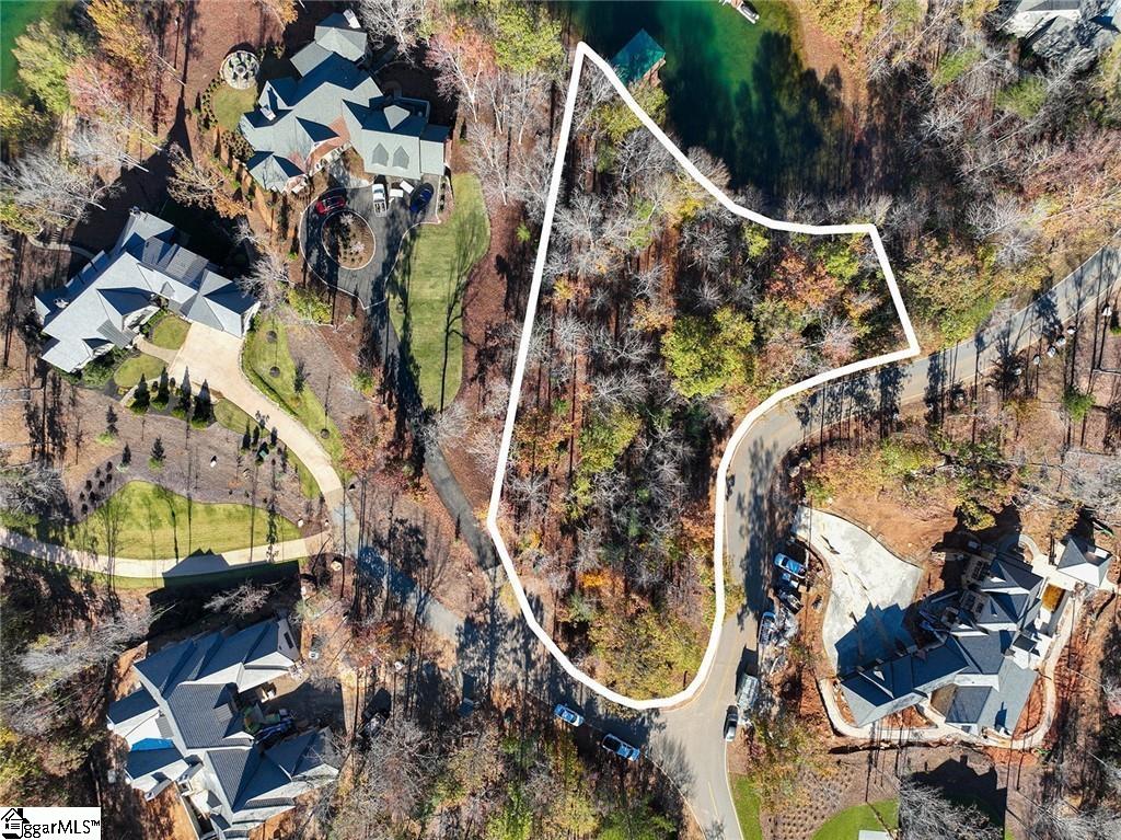 Looking to build the home of your dreams in an exclusive and serene community on Lake Keowee? Lot 40, located on Waterscape Drive is what you’ve been looking for. You will love the location of the lot and how a future home would capture the abundance of natural light from the rising sun in the morning, but be sheltered away from the hot, afternoon sun. This creates longer, more enjoyable lake days on your brand-spanking-new dock in what is seemingly your own private mini-cove. If you decide to venture out and see the beauty that awaits you on Lake Keowee, you’re just a couple of minutes from the main channel of the lake while still being shielded from watercraft wake on your dock.