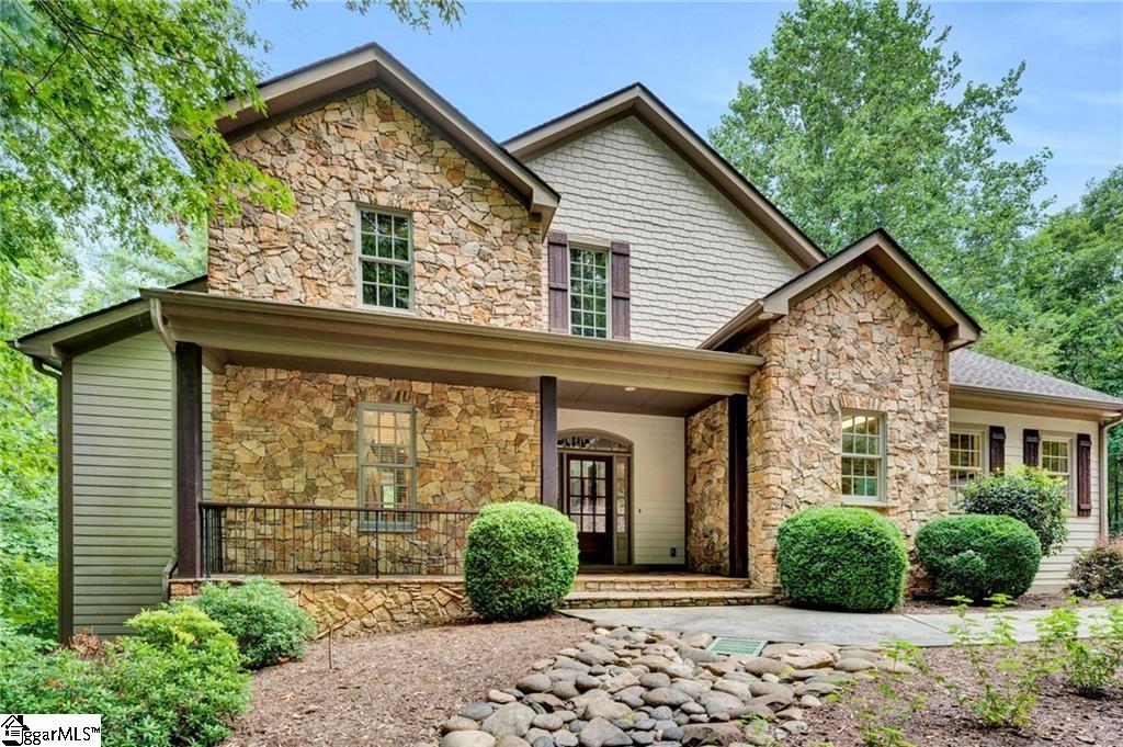Professionally updated with beautiful and purposeful design, this private, waterfront home awaits you at the Cliffs at Keowee Vineyards! 107 Fire Pink boasts two large master suites and separate full kitchens on both the main and lower level. Tucked away in a picture-perfect private setting in the woods aside a deep-water cove for you to enjoy all this property has to offer on its 1.29 acres. Step outside on one of the two large porches on each level overlooking a simply gorgeous area of Lake Keowee. Just off the lower porch is a fire pit patio that allows you to take in the nature-filled views. Perfect for hosting large gatherings and family/friends – there is plenty of room for everyone with this 5-bedroom home. The main level includes the master suite with a cozy sitting room and spacious master bathroom.  The upper level includes 3 bedrooms with a full bath.  The second master suite on the lower level along with another flex room which the current owners have used as an additional bedroom allows for versatility for large family and friend gatherings. Beautifully finished wood floors, custom features, and soaring wood ceilings showcase the light and bright aura from the large windows that highlight the lake views. The Cliffs at Keowee Vineyards is a gated community offering remarkable amenities. This home has a spacious dock that could easily be customized even further if desired. This stunning home awaits your jaw-dropping visit experience!