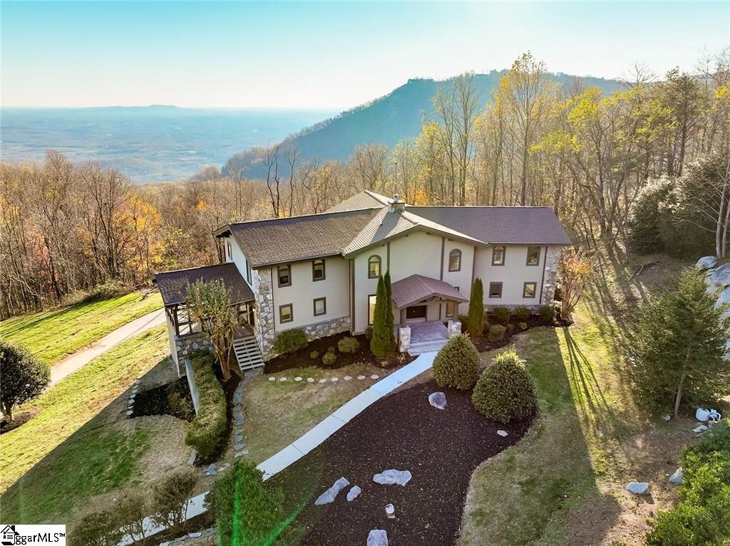 Perched on the summit of Glassy Mountain, this impeccable parcel provides one of the best views imaginable in the Upstate. Step outside and take in the fresh air and remind yourself of the serenity you have rewarded yourself with. This immaculate estate located in The Cliffs at Glassy started in 1992, but you won’t be able to tell after crossing the threshold at the front door. Everything inside and out is brand new and captivating.  The quartz kitchen is spacious enough to host and entertain the largest of crowds. The soaring ceilings in the family room boast an open feel with a wall of windows and access to the deck but can also be intimately staged around the gas log fireplace. The party continues downstairs with a spacious and open recreational room with another gas fireplace. Whether you’re a car collector, or just prefer to garage your cars, 68 Raven can accommodate 3 cars and still have plenty of room for storage or a workshop. The bedroom suites on the main level and second floor are tucked away from the main area of the home for privacy and peace.  Close to Greenville, you are never far away from the action as well as any shopping, medical facilities, restaurants, and the GSP International Airport. The Cliffs at Glassy is an absolute gem tucked at the top of Glassy Mountain and offers world-class amenities to their members, there is something for everyone here. Most would regard their choice of this community as the best choice they have ever made. From the top of the mountain, home is calling you.