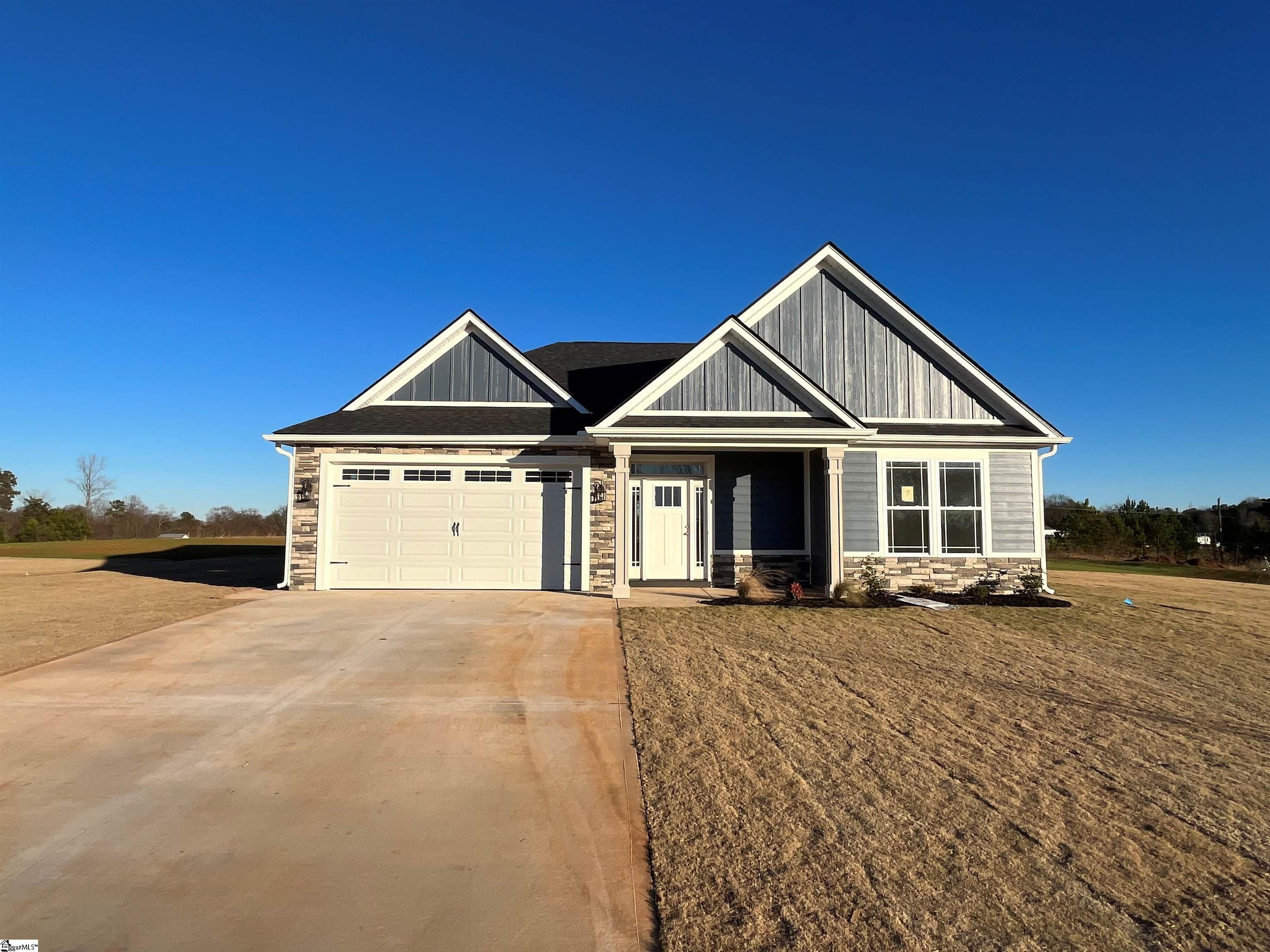 Welcome to your dream home! This beautiful new construction on a large 1 acre lot, is situated in the picturesque town of Inman, South Carolina, offering breathtaking mountain views that will leave you in awe.   Step inside and you're greeted by a spacious entryway with trey ceiling that leads into a large living space with gas fireplace. You'll love the bright and inviting sunroom, perfect for enjoying your morning coffee or relaxing with a book. The open floor plan seamlessly flows into the gourmet kitchen, featuring stunning granite countertops and stainless steel appliances. The cement board siding adds durability and low maintenance to your home.  The luxurious master suite is a true oasis, featuring a fully tiled shower with dual showerheads, making every morning feel like a trip to the spa. The additional bedrooms are generously sized and offer ample closet space.  This home boasts impeccable attention to detail and craftsmanship, ensuring quality and longevity for years to come. Don't miss the opportunity to call this stunning home yours and enjoy the peacefulness and serenity that Inman has to offer. Schedule your private showing today!