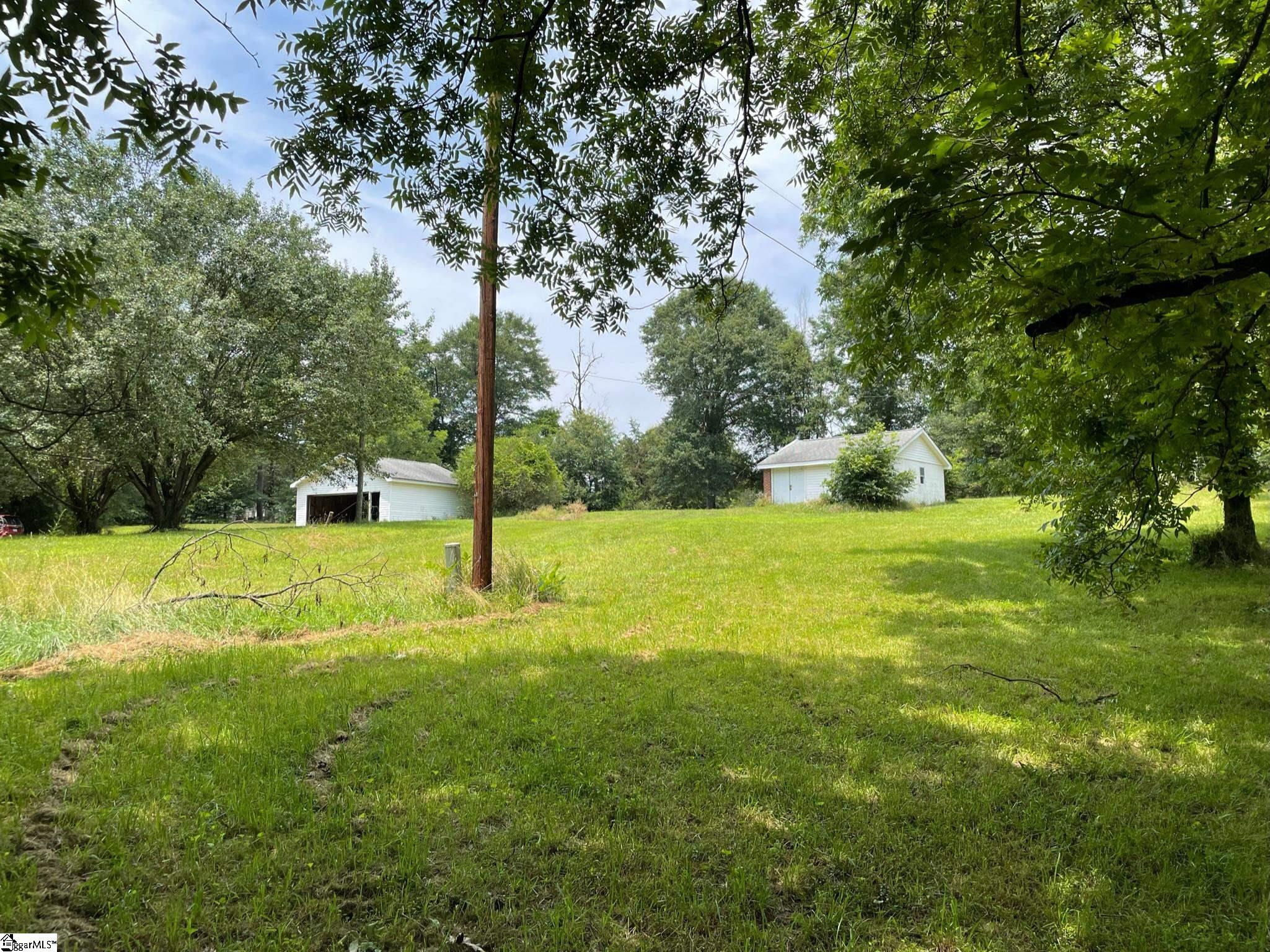 1.55 Acres with utilities, garage, outbuilding, beautiful mature oaks and pecan trees is ready for you to build your dream home!  No known restrictions, so tiny houses and mobile homes are welcome, as well!    A home once stood on this fabulous property, so all utilities are believed to be in place.  A covered well that the house was NOT utilizing is located near the back of the property.  Home was connected to Big Creek Water.  Located in a quiet area in the desirable Anderson School District One.  Come see 340 Old River Road today and start making your building dreams come true!  APPOINTMENT REQUIRED. PLEASE DO NOT WALK LAND WITHOUT CONTACTING LISTING AGENT!
