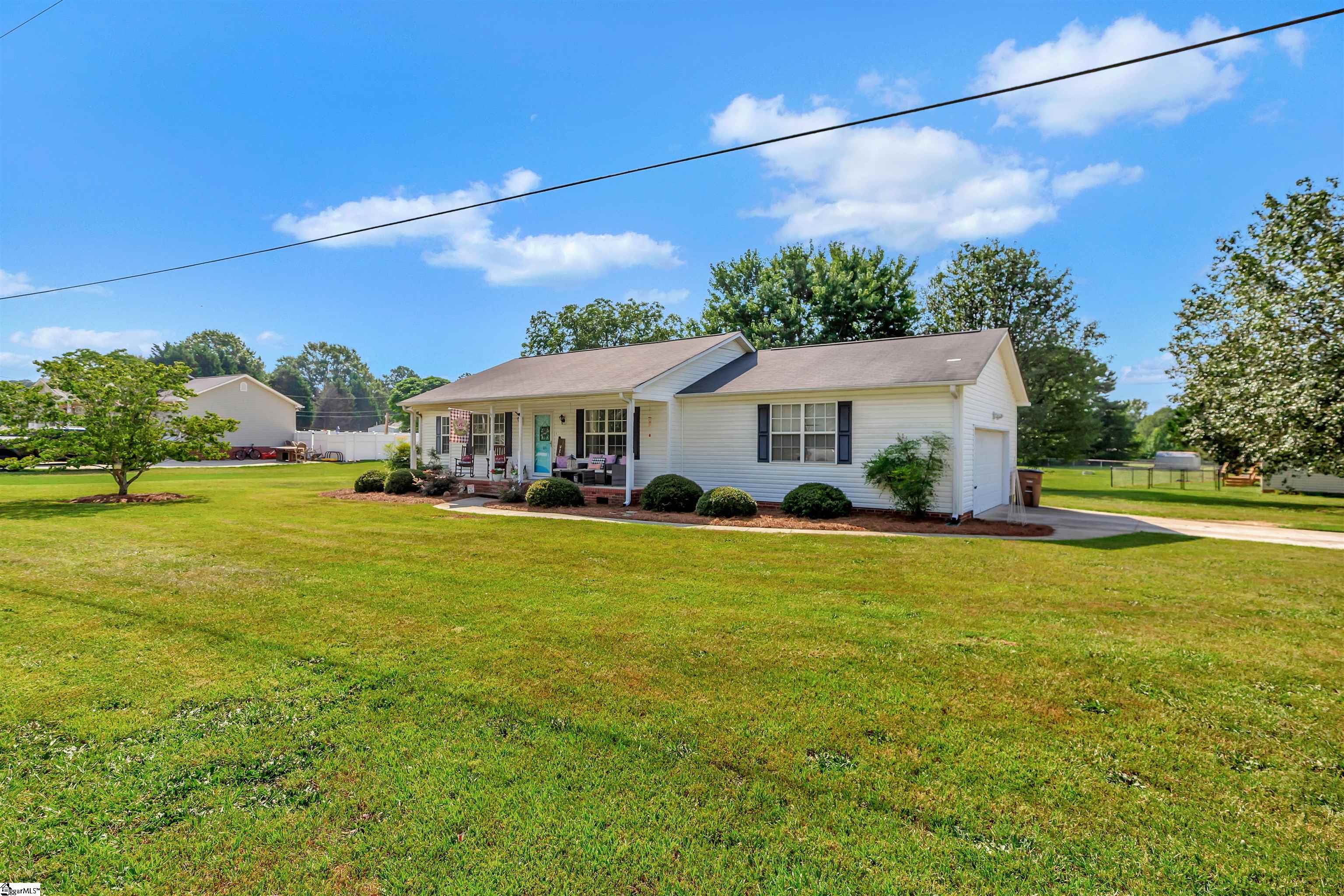LOWER COMMUNTE time. Spend more time doing what you LOVE with this one-level living conveniently located between Anderson, SC, and Greenville, SC.  Hop on I-85 at EXIT 32, and you can be at the Greenville Spartanburg airport in 20 mins. Help yourself to a southern home-cooked meal in the eat-in kitchen, complete with natural light. Quiet doses of relaxation after a long day in the den, or retreat to the front porch with a glass of sweet tea and tranquility. EASY maintenance living with hardwood flooring throughout this right-sized home. Soak in the SUN and experience PRIVACY with the oversized fenced-in backyard to add protection to your pets and loved ones. OVERSIZED two-car garage perfect for the hobbyist. ENJOY the established neighborhood with AFFORDABLE living. Sq footage is 1283, septic was pumped in 2022, roof is 12 years old- getting disclosure corrected