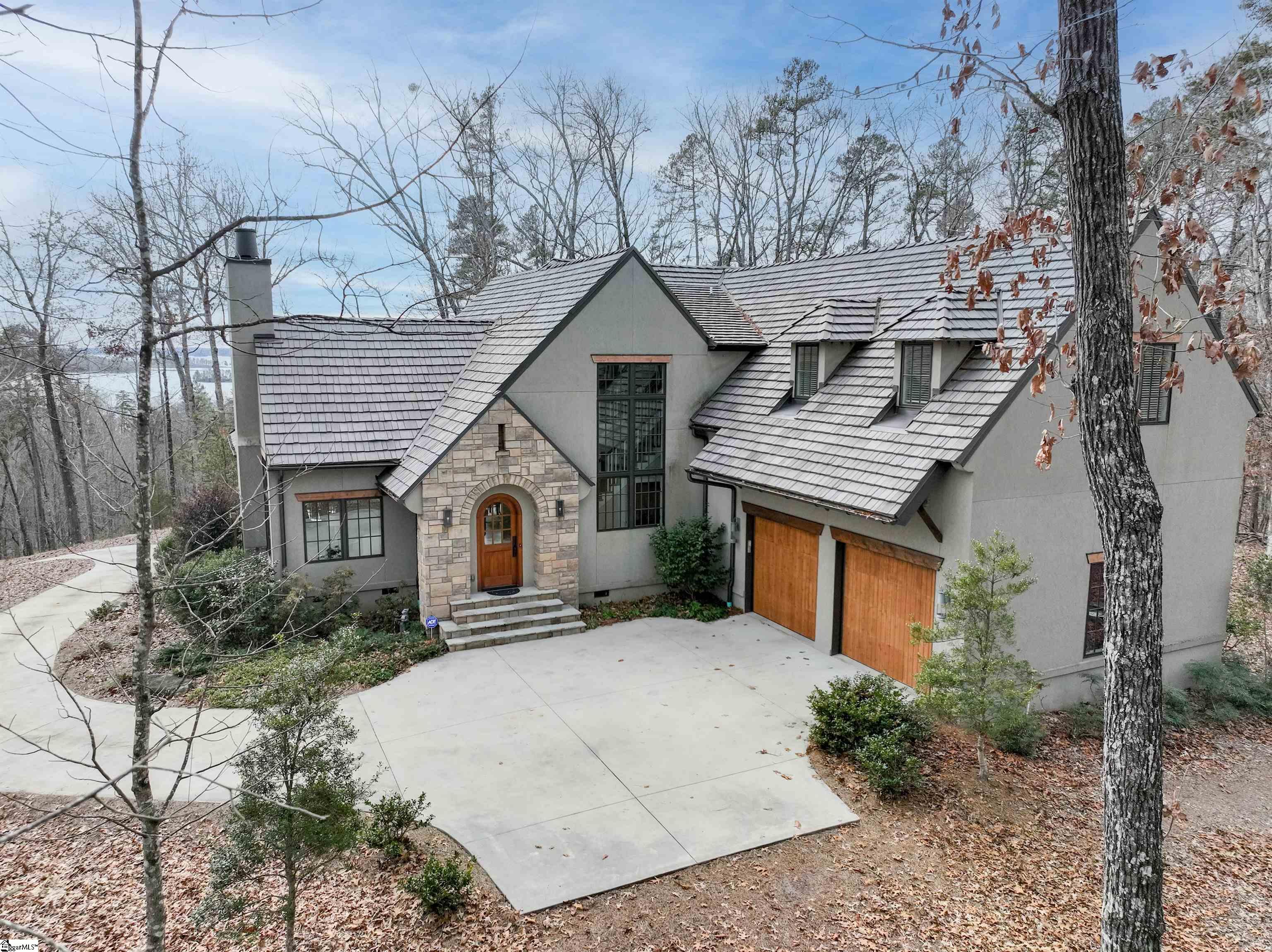 151 S Falls Rd: An opportunity to purchase a beautiful home with exceptional privacy and a picturesque, and literally miles-long, view of Lake Keowee! This one-owner home was custom built in 2014 and is just the right size with all the right features. The gently sloping driveway winds up the 1.73 acre property to a perfectly flat homesite that is only bordered by one residential lot, providing unmatched privacy and natural beauty. The open floor plan is inviting, bright, and ideal for everyday living and entertaining. The owners have done a great job of blending mountain/lake elements, like beams and tongue and groove ceilings, with modern color tones and finishes. The home is well designed and takes full advantage of the AMAZING year round, long range lake view, including the living room, kitchen, dining area, owner's suite, office, guest suite, and of course the large screened porch and back patio. You'll love cooking in the kitchen with its 5-burner gas cooktop, double wall ovens, large prep/serving island, and great butler pantry/storage nearby. The primary suite is conveniently located on the main level and has a nicely appointed bath with a walk-in shower, soaking tub, double sink vanity, and large walk-in closet. The current owners have enjoyed working from home, and you'll understand why when you see the natural light and views from the upstairs office! There are two generous guest suites and an additional family room upstairs, so your guests will always be comfortable and entertained. While this home and property provide exceptional privacy, The Reserve at Lake Keowee provides world class amenities and social options over its 3900 acres. The Jack Nicklaus designed 18 hole golf course, tennis/pickleball courts, fitness/wellness center, resort style pool, private marina, hiking trails/parks, and amazing culinary options are just a few of the amenities The Reserve has to offer. Notes: 50 year Davinci Engineered Shake Roof. Main level heat pump and both air handlers replaced 2023. Pre-Listing home inspection done and only minor repairs were needed. Ask agent for inspection reports, if desired. Membership information in Supplements. This home has an original Full Membership that is convertible to Premier/Full, Sport or Social.