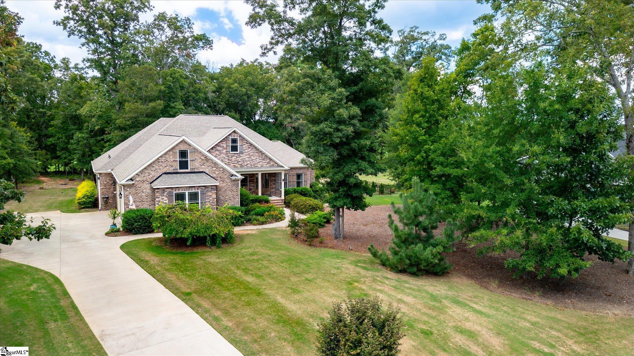 Beautiful, custom built single-story home, nestled in the trees, on 1.21 acres in Ridgewood Plantation is waiting for you to make it your new home!   You will immediately notice the curb appeal with lovely landscaping and expansive private yard.  This home has so much to provide with a rocking chair front porch and custom designed double front doors that welcome you inside to the foyer with a full view of the open, split floorpan.  You will enjoy the central area of the home,  designed for entertaining with formal dining room, living room with shiplapped gas log fireplace, soaring ceilings, a chef's kitchen with custom cabinets, granite countertops, gas range and pantry with oversized breakfast nook also with shiplap.   On the right side of the home you will find two guest rooms with a connecting full bathroom.  On the left side of the home there is a private hall that leads to the fabulous owners suite, with tray ceiling and adjoining bath with walk in tiled shower, double vanity, soaking tub and walk-in closet.  A massive laundry room with storage and counter space, a tucked away guest powder room and coat closet complete this homes interior.  Out back you can enjoy peaceful starry nights on the stone patio, roasting marshmallows around the built in fire pit, play in the newly fenced yard, walk the path in the woods or hang out on the screened in porch.  There is a possibility to add a future room over the two car garage or just use the attic for added storage.  There are so many extra features like a front yard irrigation system, gutter guard, tankless water heater, wood floors throughout (no carpet) and so more! Ridgewood Plantation has a community clubhouse and pool to enjoy and a country feel while being conveniently located near Anderson and Greenville.  Come visit 28 Ione Circle today and make it your new home sweet home!