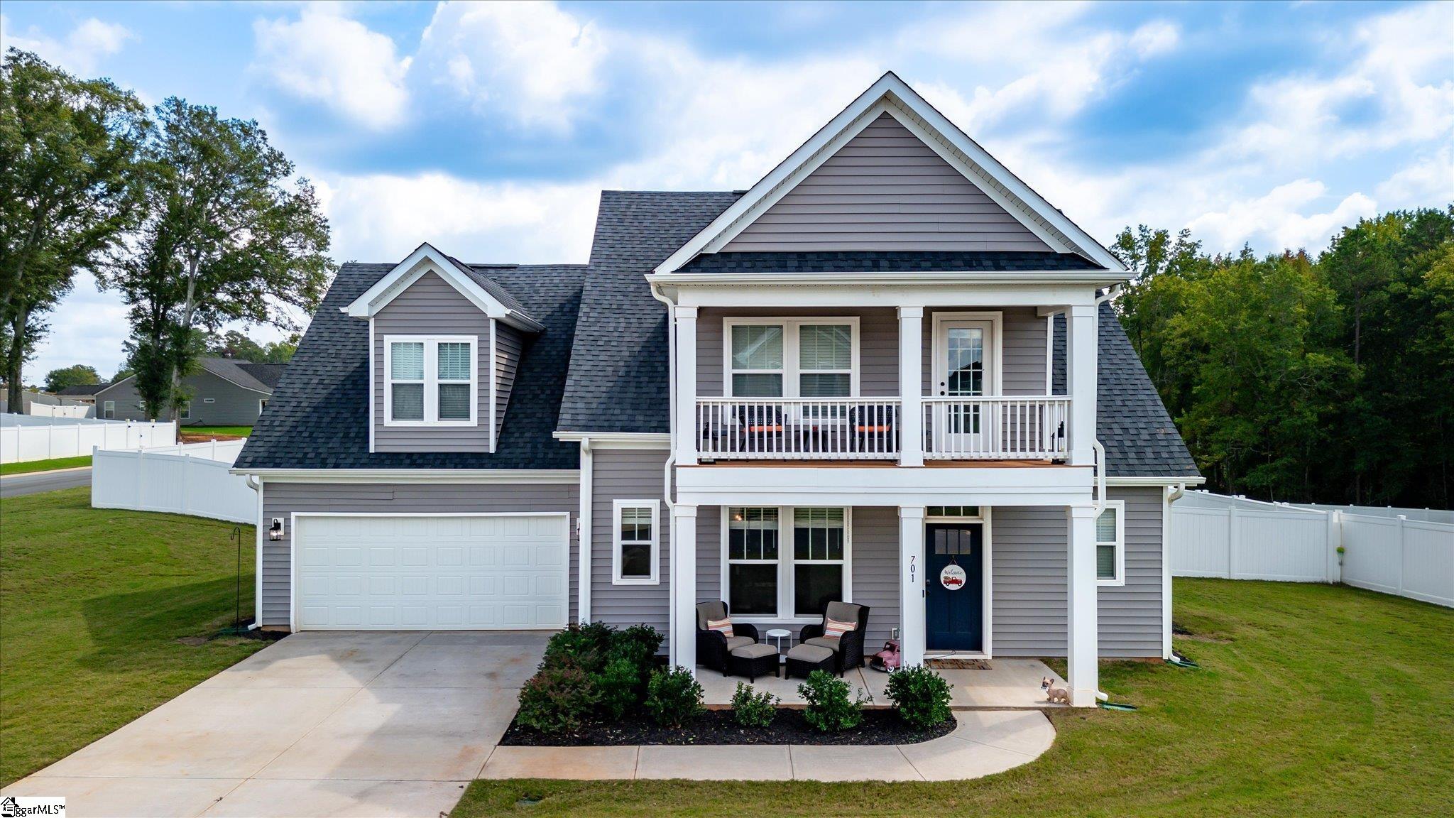 If you are looking for a new home with the Owners suite on the main floor, and a second suite upstairs, then this is the perfect home for you!  Upon entering the home, from the welcoming front porch, you are drawn into the formal entry with powder room and adjacent dining room with crown molding and stylish lighting. The open flow to the kitchen, from dining room or living room with a wall of windows, soaring ceilings and cozy fireplace makes this home perfect for entertaining. The kitchen is a cooks dream with gas range, a large center island, which allows for extra prep space, white cabinets and granite countertops. The adjoining open breakfast room, has ample space for a large table, if desired, adding to the entertaining space.  The screened porch, off of the breakfast room, is the perfect spot to enjoy the fall football season, already with a tv in place, that will stay with the home! The huge fenced backyard, is such a pretty place, with a tree view and is ready for pets and kids to enjoy or make future plans for a garden! Back inside you will find a separate laundry room off of the kitchen and entrance to the two car garage.  The owners suite, which is tucked away, includes a spacious walk-in closet, double sinks in the bathroom, as well as a generous sized tile shower with seat and a linen closet. As you reach the top of the staircase, that overlooks the living area, you will find a bedroom on the left, with large walk-in closet and private balcony, with adjoining bath.  The unique Sutherland floor plan has a bath, with two separate private vanity areas that also opens to the hallway, making it easy to share with the bright bedroom across the hall, also with walk-in coset.  The third bedroom serves as your second suite with three walk-in closets and attached bath!  With over 2,700 square feet, this home is sure to fit all your needs and allows for privacy, when needed, with the split floor plan.  This lovely home is located in, the almost completed, Breckenridge Subdivision, with desireable Anderson District One schools.  Come visit and make 701 Oak Hill Lane your new home today, just in time for hosting for the holiday season!