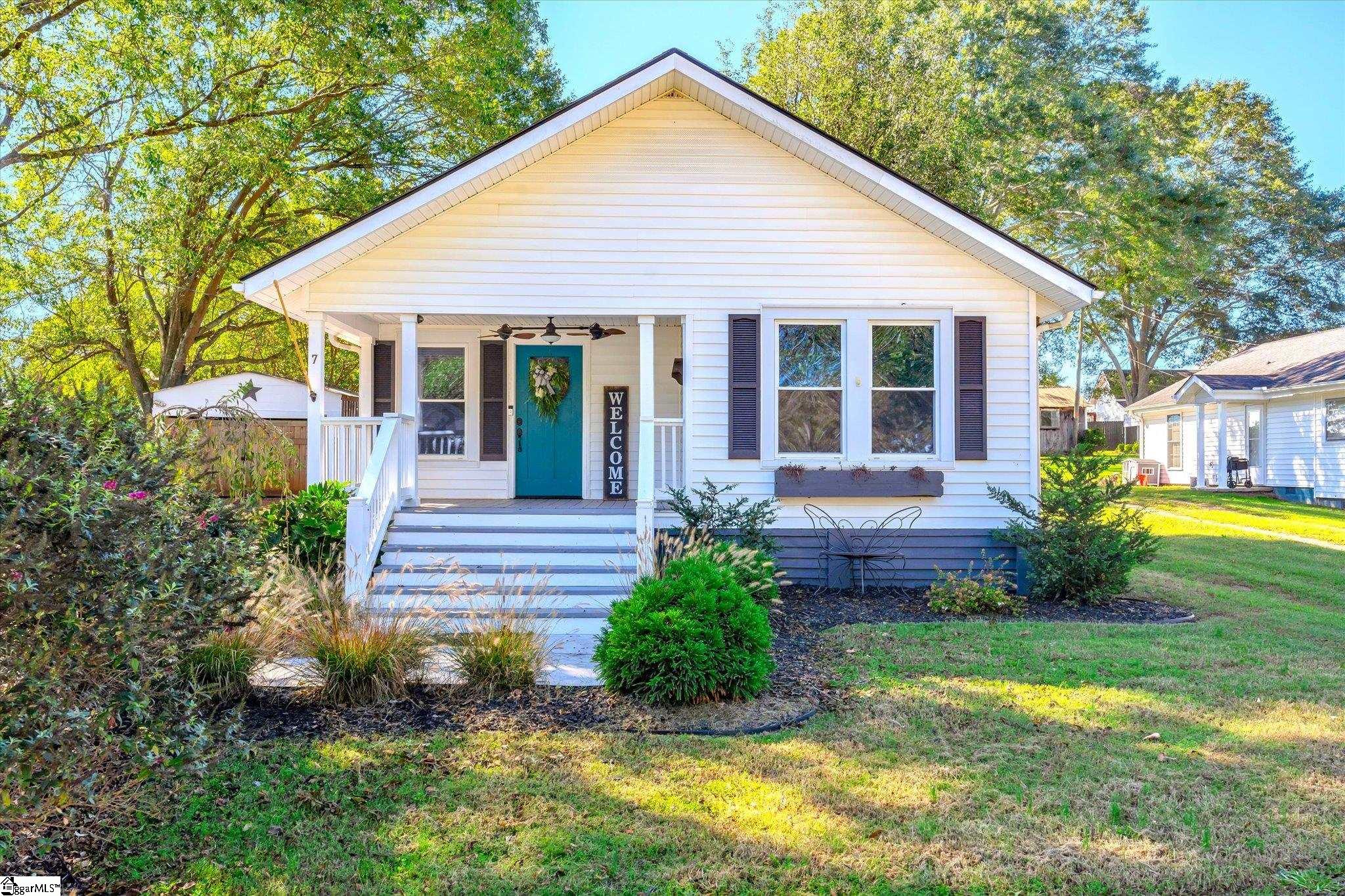 Sweet updated bungalow is ready and waiting for new owners in the West Pelzer Community! You will immediately notice the pride in ownership as you pull in the driveway with butterfly bushes, a goldfish pond with custom rock fountain and welcoming front porch to greet you! As you enter the home the living room with decorative fireplace flows openly to the large dining room and onto the kitchen.  The kitchen has been updated in recent years with new cabinets, custom concrete countertops, and includes all appliances with a double oven, just in time for holiday baking!  The spacious laundry room with storage leads you outside to the spectacular fenced backyard featuring several deck spaces with pergola for grilling and entertaining.  Back inside you will find three large bedrooms and a centrally located bathroom to complete the home.  Your new home also includes a detached garage for storage and the original hardwood floors are under the laminate flooring, if you prefer that style. You will enjoy easy walks to downtown West Pelzer with many restaurants, shopping and playground!  Centrally located to Greenville, Anderson and Easley with Anderson District One Schools makes this a great location for all Upstate South Carolina has to enjoy! Come make 7 Park Street your new home today!