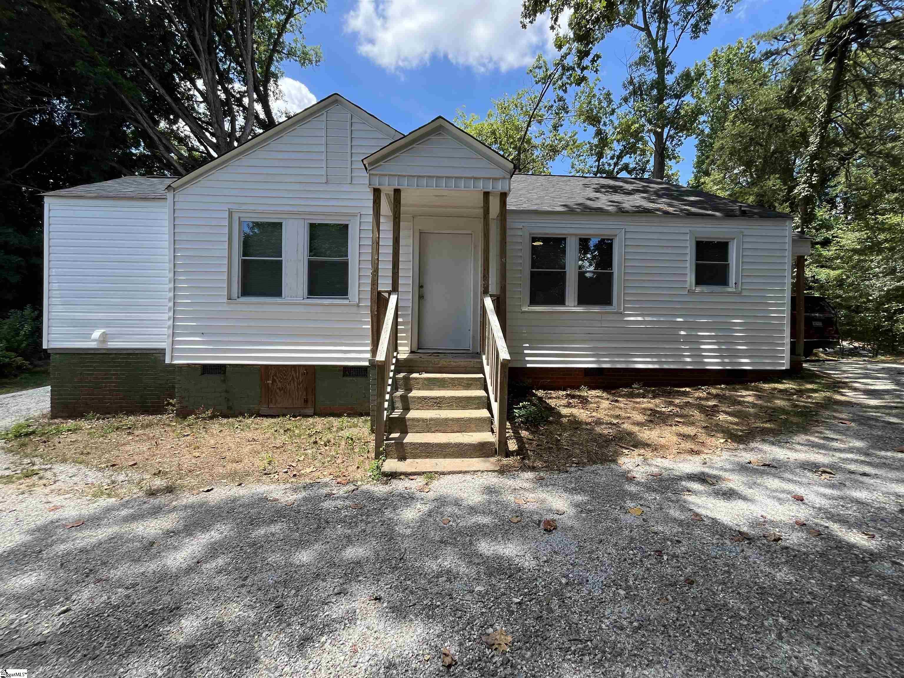 Now asking only $215,000! Welcome home to your cute updated bungalow, that is nestled in the trees, which makes it feel so private.   Your new home features three bedrooms, a large living room and dining room as well as an updated kitchen with new cabinets, countertops and full appliance package.  The huge laundry room includes washer, dryer and plenty of room to add shelves for storage, if desired.  This bright home has fresh paint, new windows and low maintenance LVP flooring throughout. The circular driveway around the home provides plenty of parking or park on the concrete pad, if you prefer.  This could also serve as a place for a future carport or storage building.  Located in a great location with easy travel to Downtown Greenville or to Atlanta or Charlotte with easy access to I-85 and also plenty of options nearby for shopping and restaurants. Come make 4002 Augusta Road you new home today!