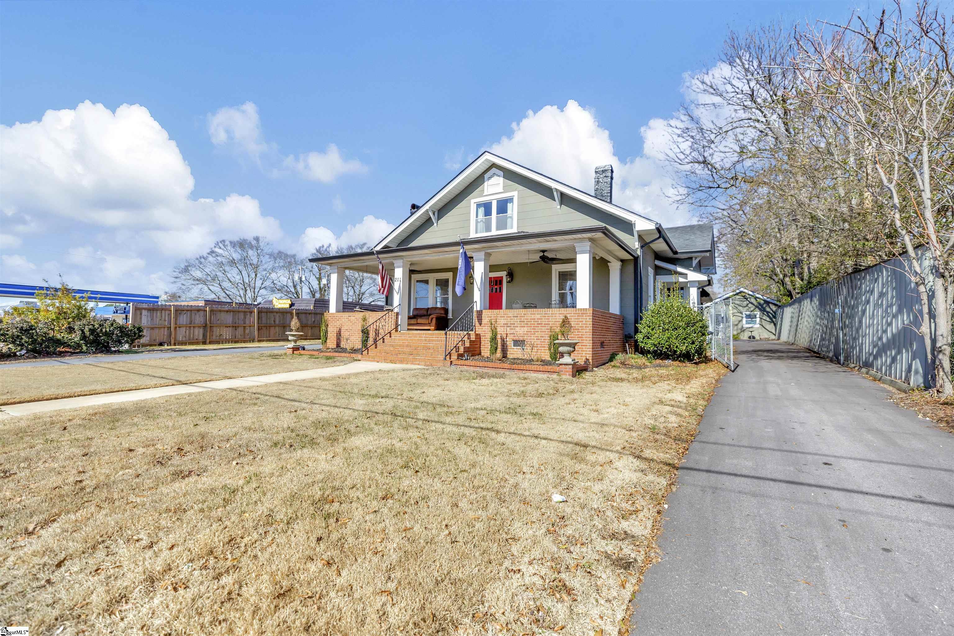 The driveway is a circular drive that leads to the main house and guest house.