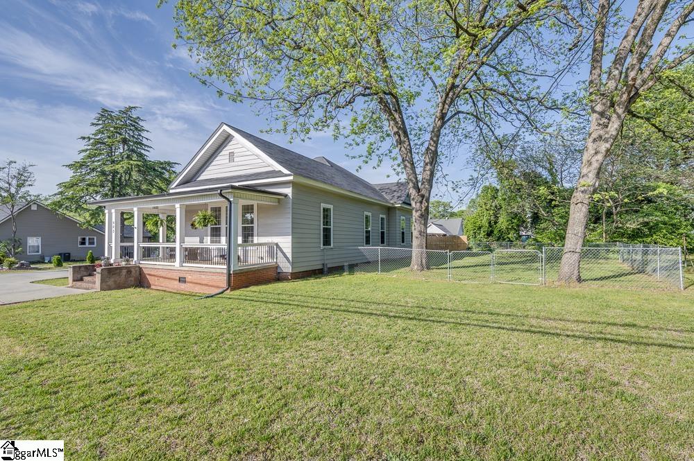 Wraparound style porch with railing offers 45x7 feet of outdoor living space.