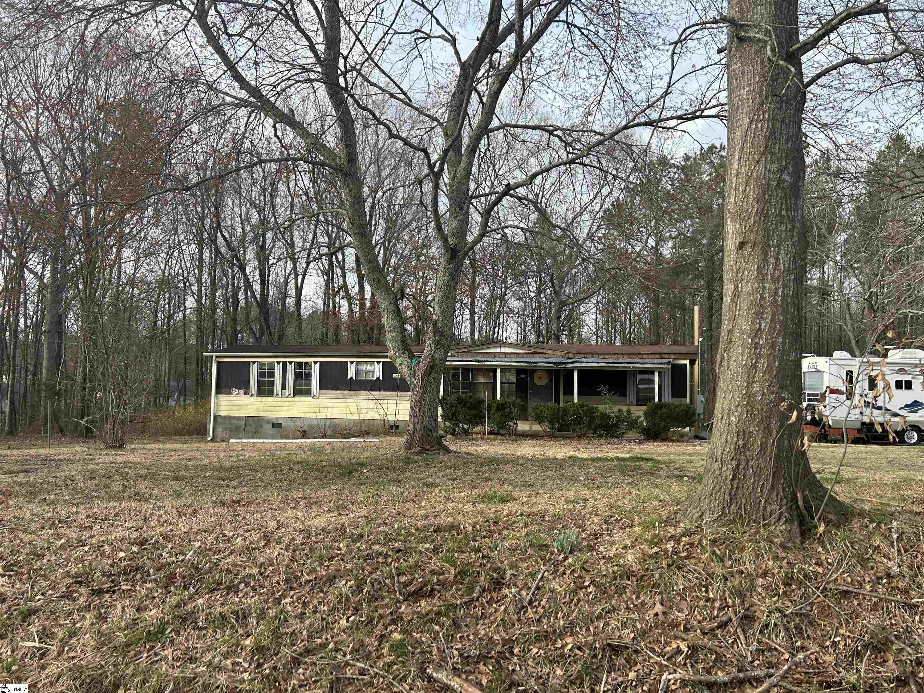 Here is a 1.2-acre piece of land on Beaverdam Road that is available! It comes with a mobile home that conveys at no additional value. The land is mostly covered in trees, but there is room to build or place a home. There is a public water tap and a septic tank on the property too.