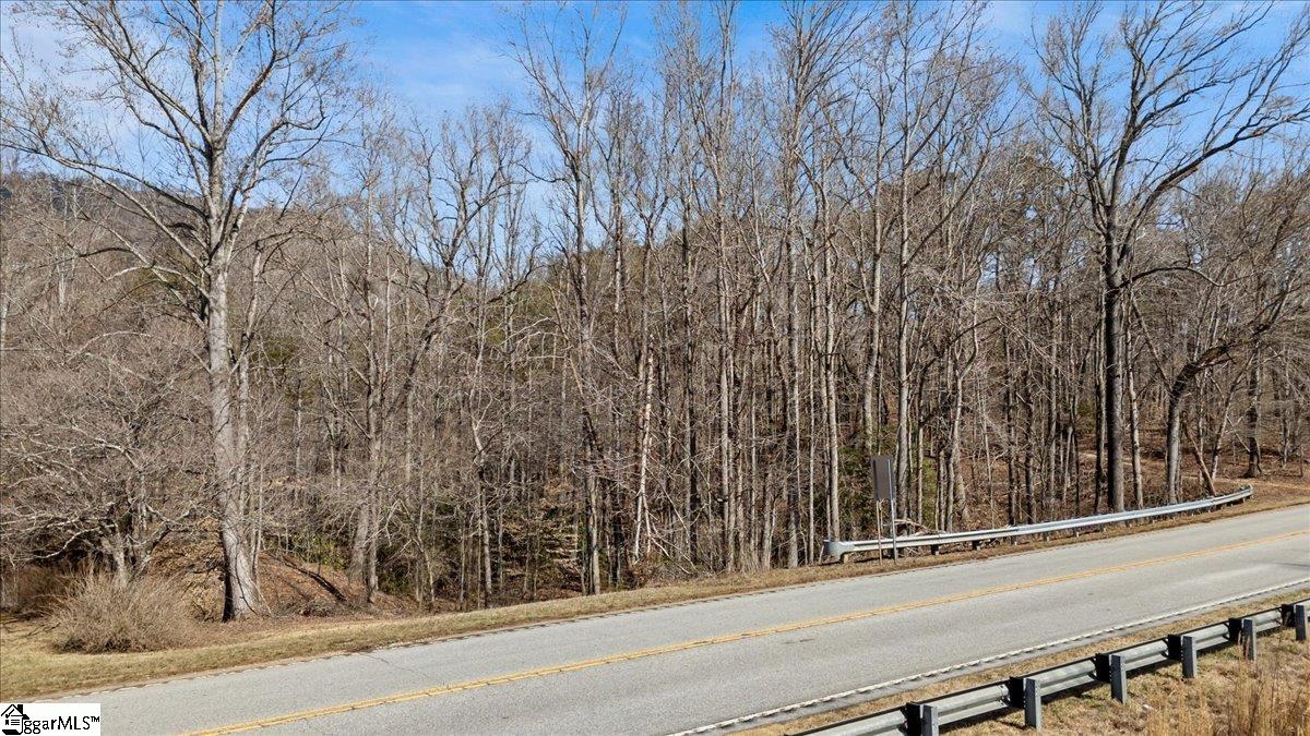 Fantastic home building site conveniently located midway between Greenville and Spartanburg on Hwy 11 near Glassy Mountain! The property features some gentle slopes, and some more level spaces. Mature trees and plenty of space back off the road. There is a driveway easement on the front section for the adjacent home, so curb cut is already in place. Septic would be necessary.