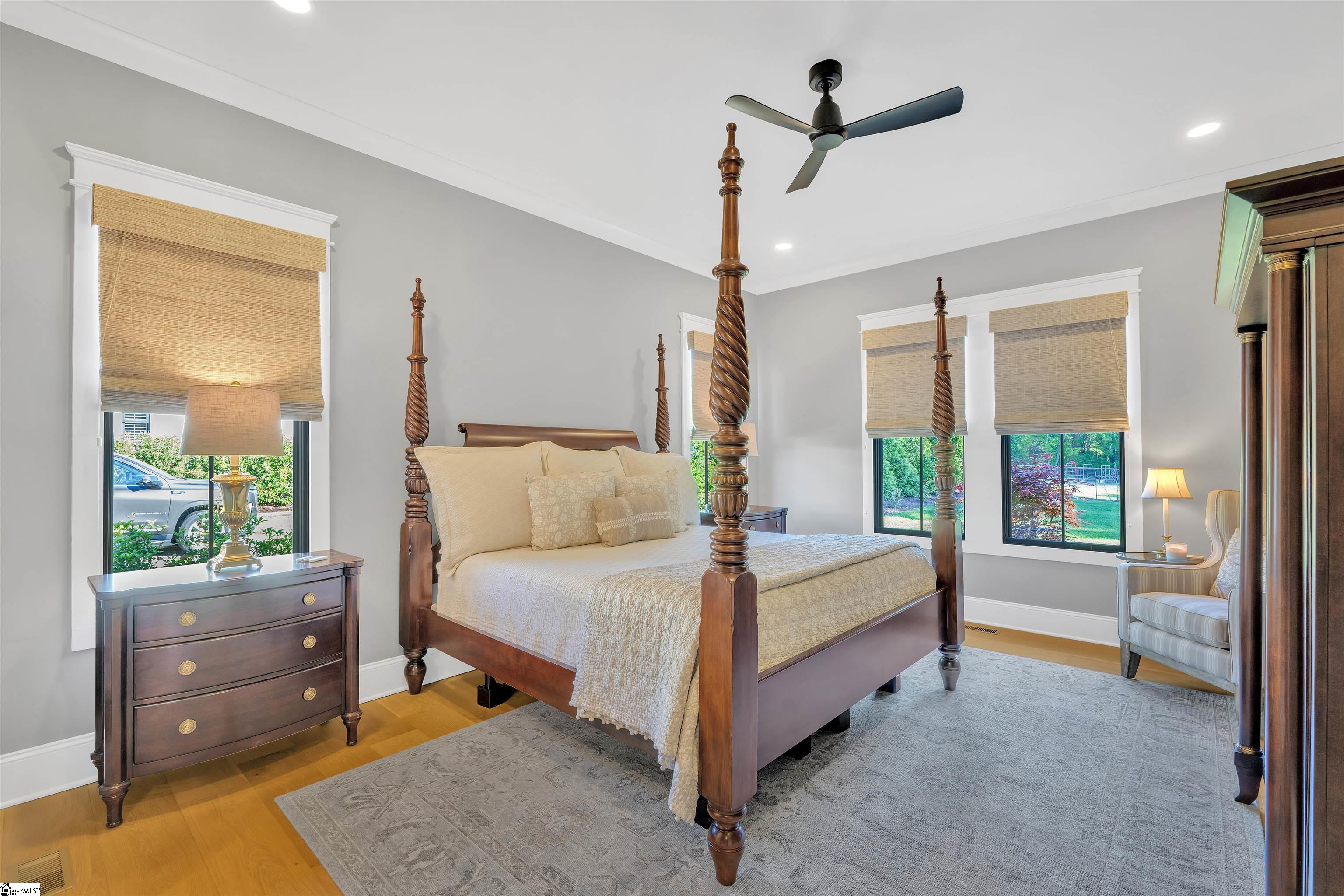 Large primary bedroom featuring 10-foot ceilings and large roll out windows.