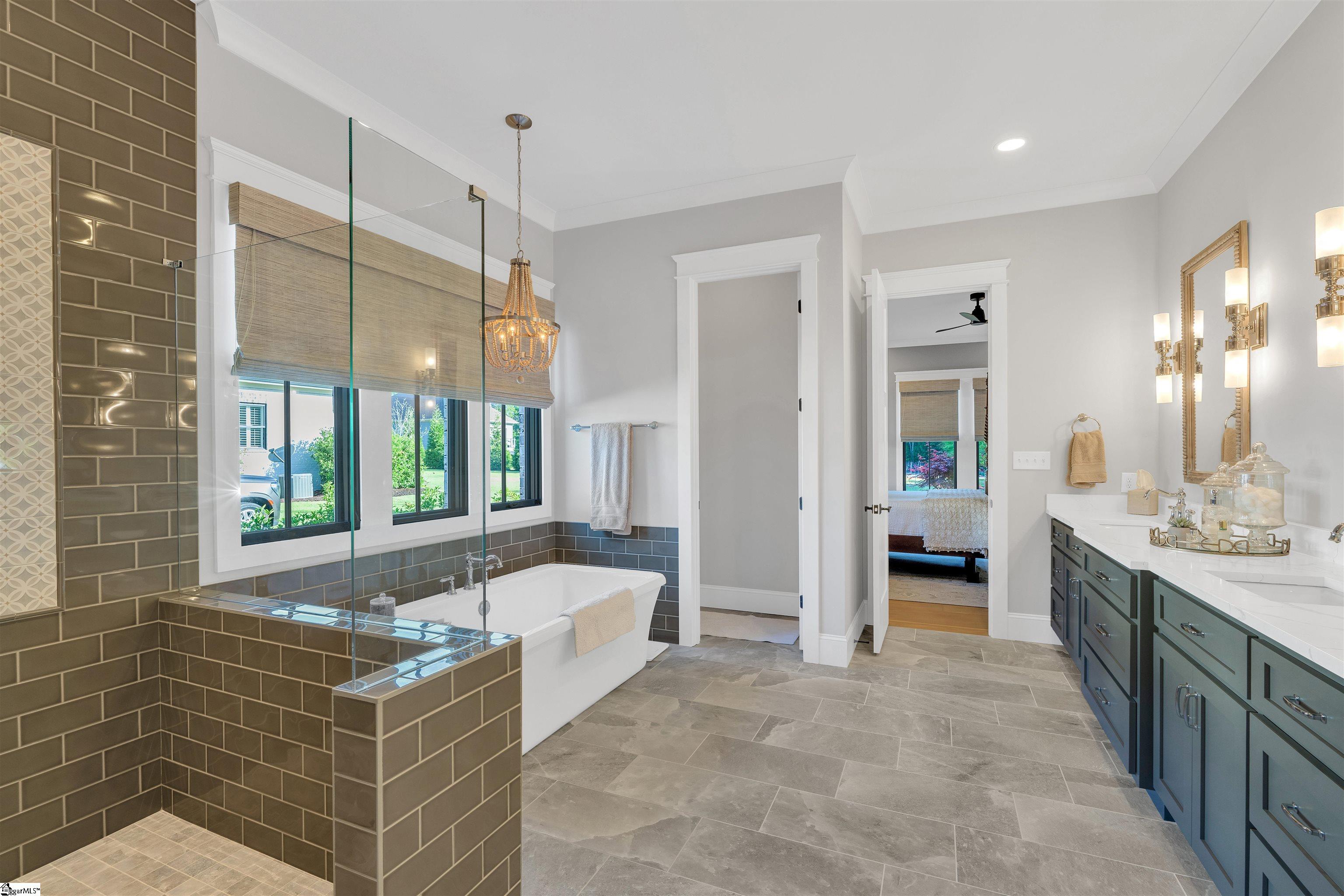 Primary On Suite with 10 foot ceilings, a long double vanity, water closet and tons of natural light.