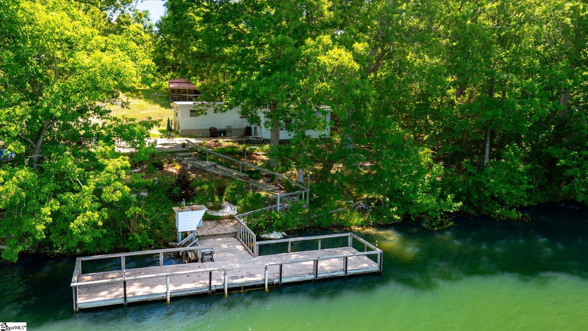 Come take a look at these two wonderful lots being sold together on Lake Secession waterfront just in time for Summer!  Ever dreamed of owning your own lakefront get away, or private retreat, then look no further!  With 180’ of shoreline, nearly 1 1/2 acres of land and a dock in place, you are ready for boating, swimming, fishing, kayaking or just enjoying a beautiful water view.  These lots are tucked in a quiet cove, but you have big water views!  Also included with the sale is a one bedroom mobile home and outbuilding (no value given).  Property is shown by appointment only.