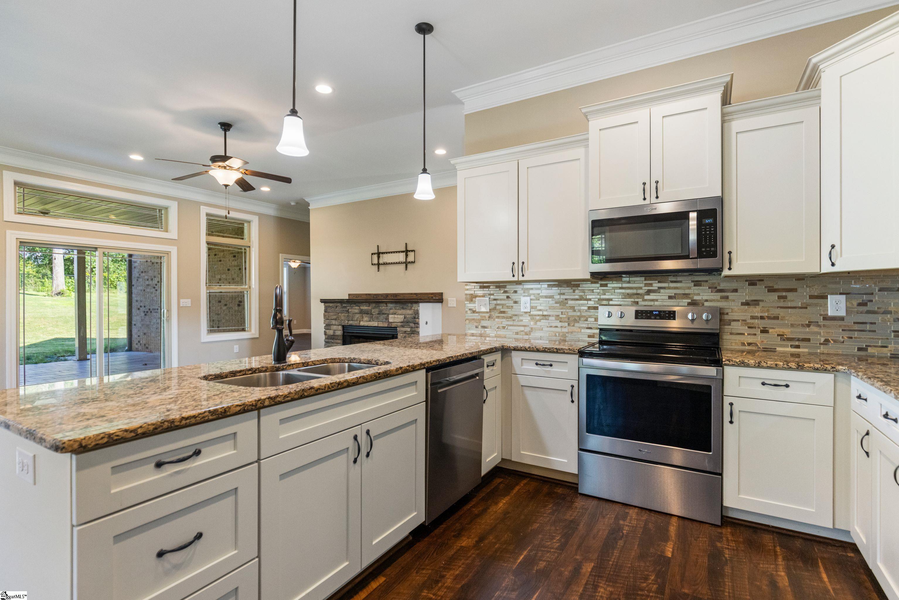 Updated kitchen featuring stainless steel appliances, granite countertops, and ample cabinetry.