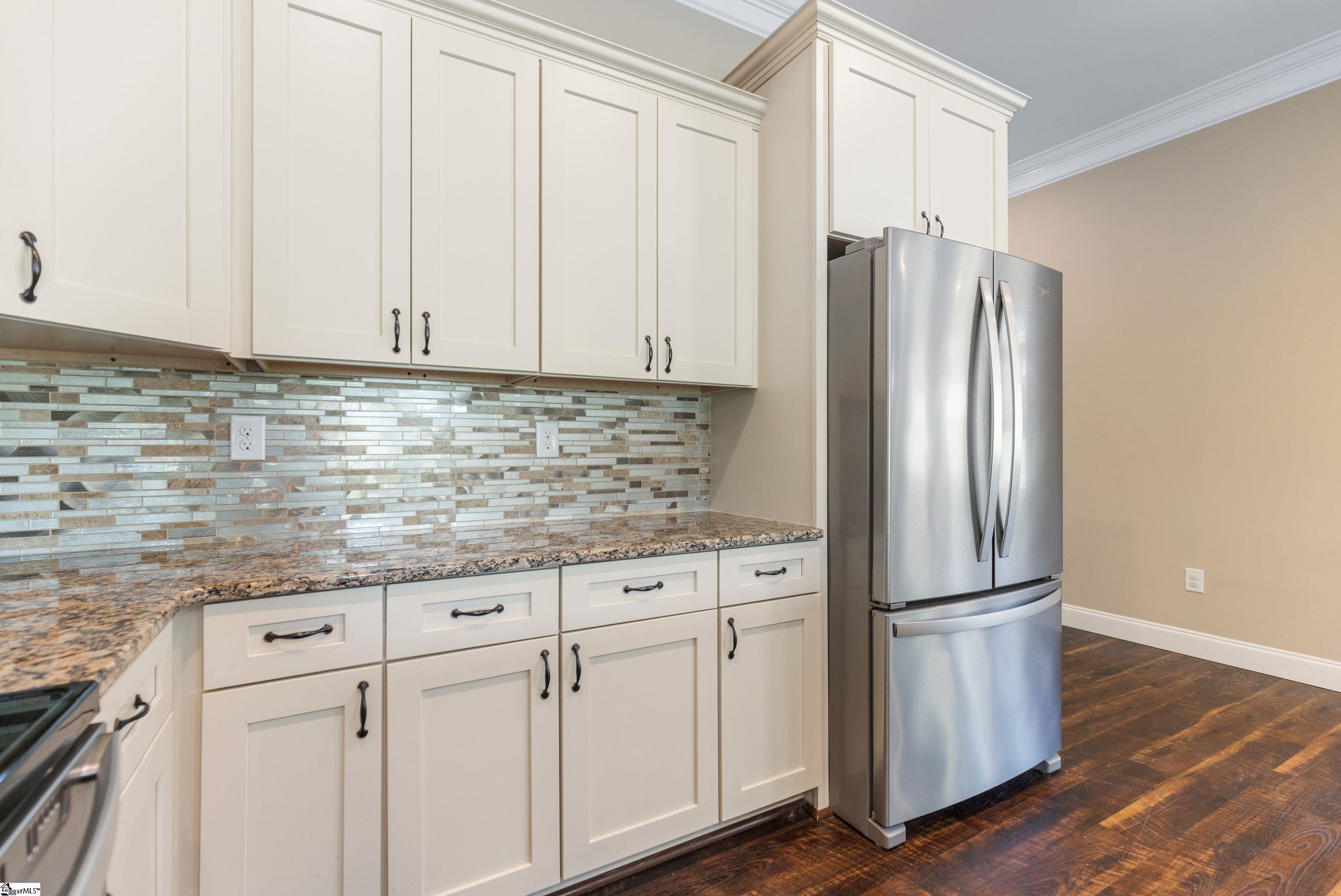 Updated kitchen featuring generous prep space and a  French door stainless steel refrigerator!