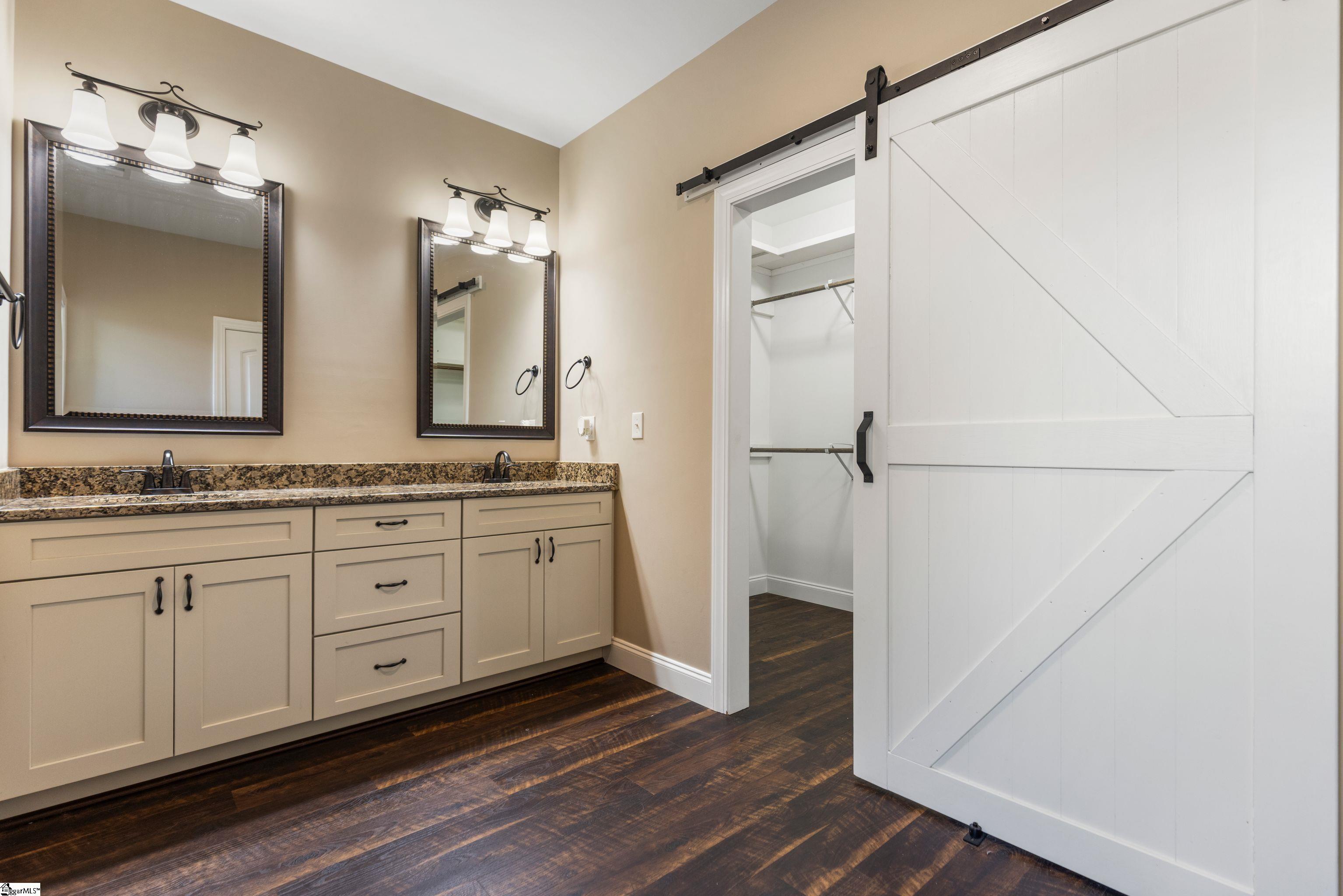 Luxurious en-suite bath with dual vanities and a fully tiled spa-like walk-in shower