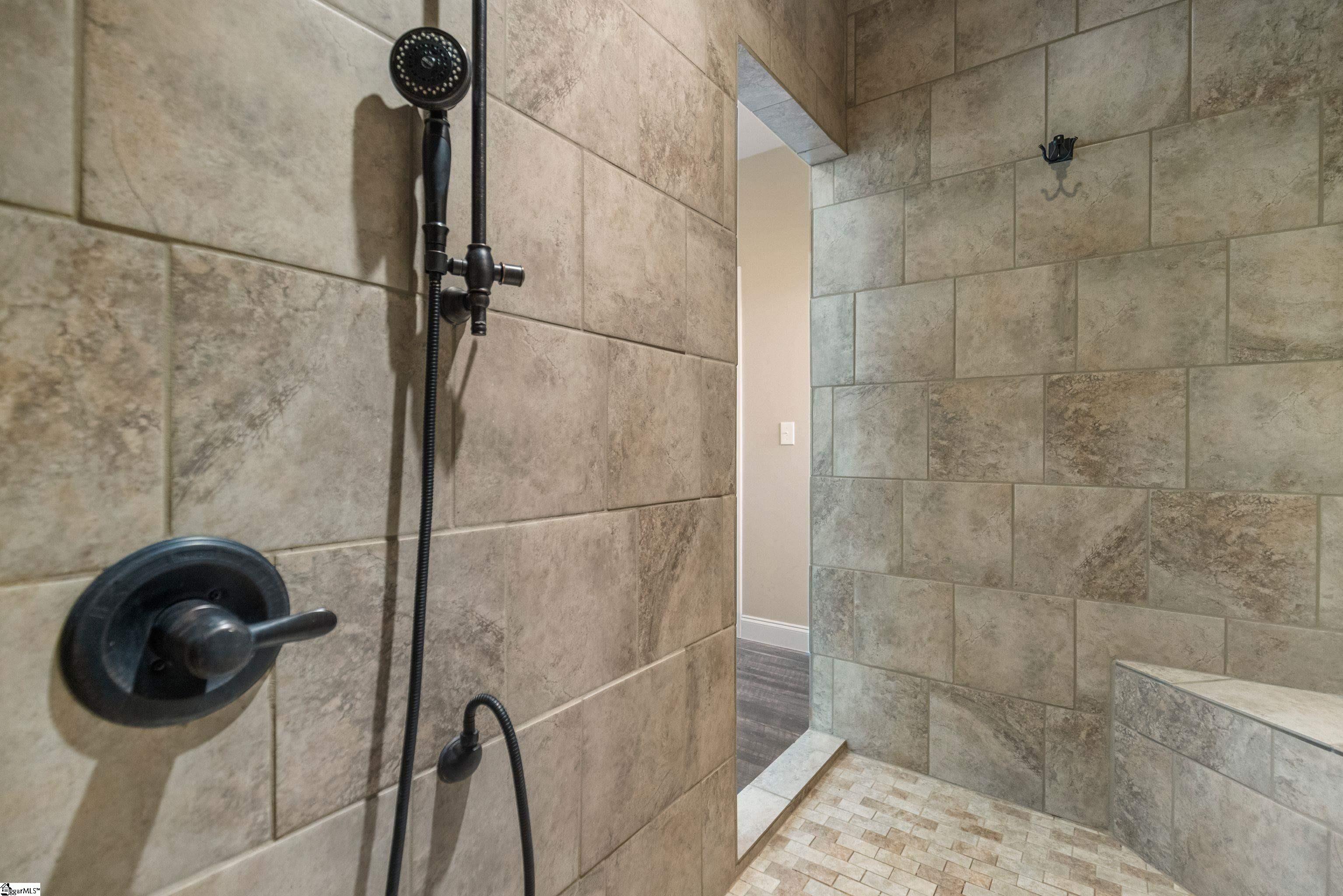 Spa-like tiled  walk-in shower featuring dual shower heads—including a luxurious overhead rain showerhead!
