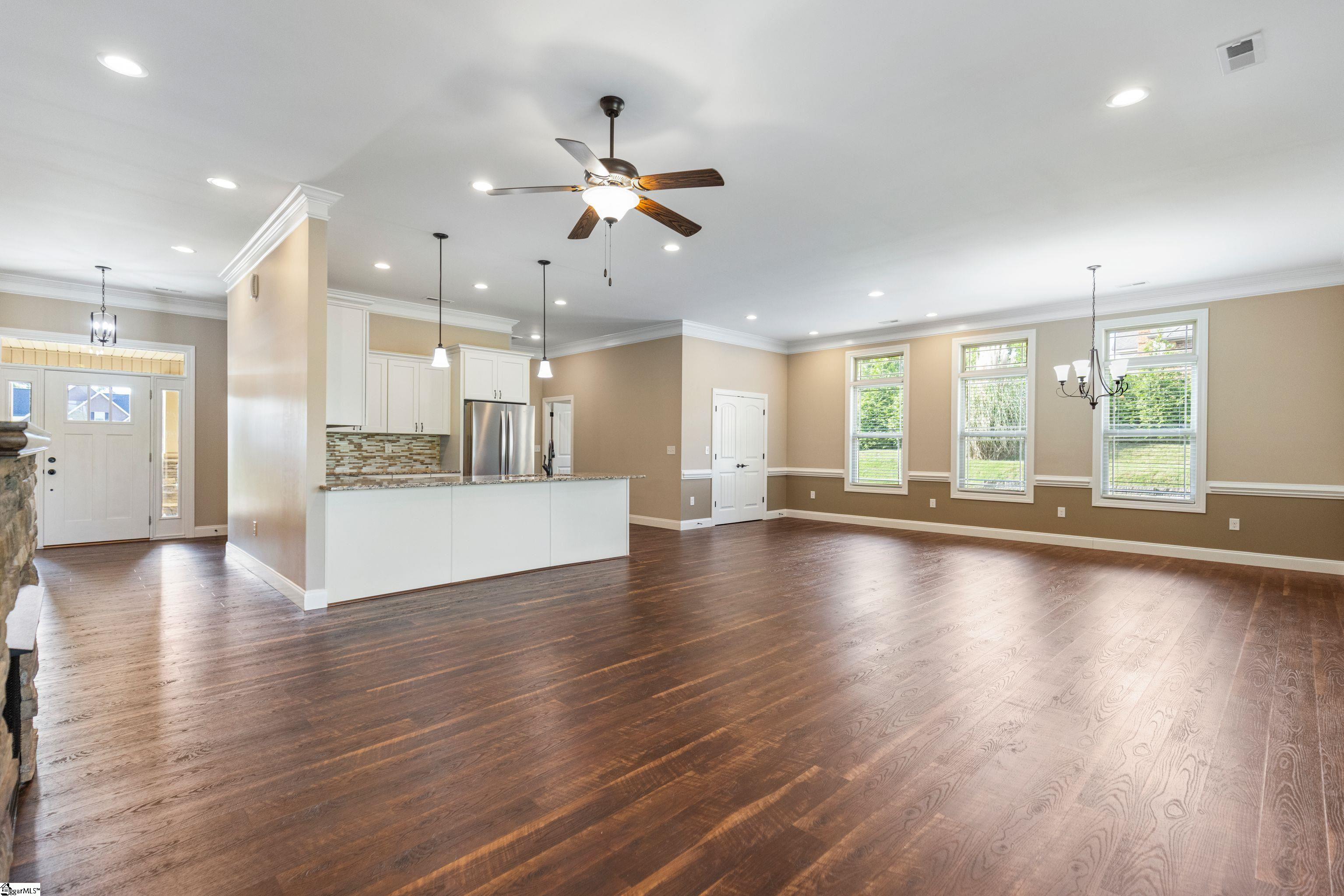 Beautiful open view showcasing the Great Room, kitchen, dining area, and foyer—highlighting the seamless flow and spacious layout perfect for modern living and entertaining.