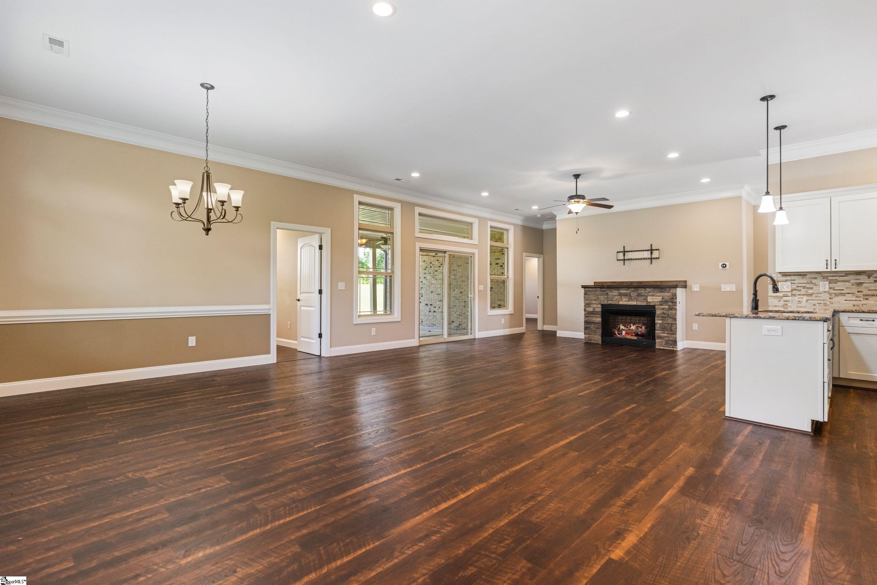 Spacious open floor plan seamlessly connecting the Great Room and Dining Area, featuring a cozy fireplace—ideal for entertaining and family gatherings.