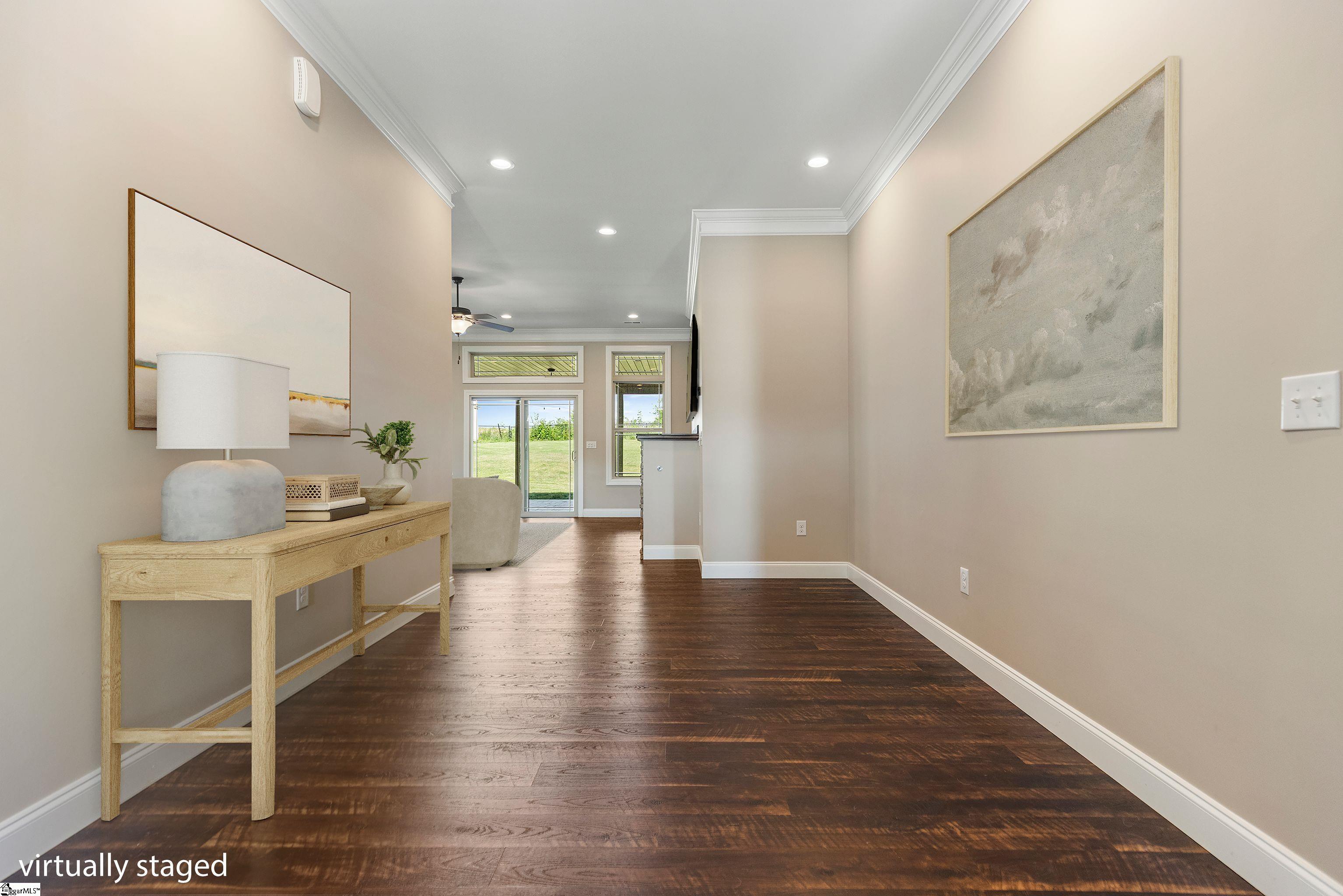 Spacious and inviting foyer filled with abundant natural light streaming through the front door—creating a bright and welcoming entry.