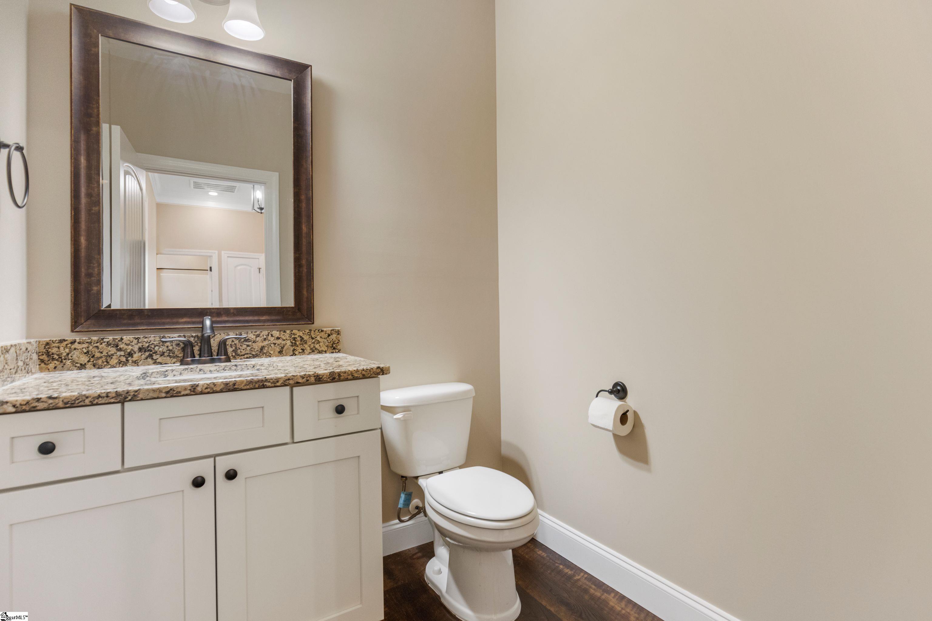 Conveniently located half bath in the hallway—perfect for guests and everyday use with stylish fixtures and easy access.