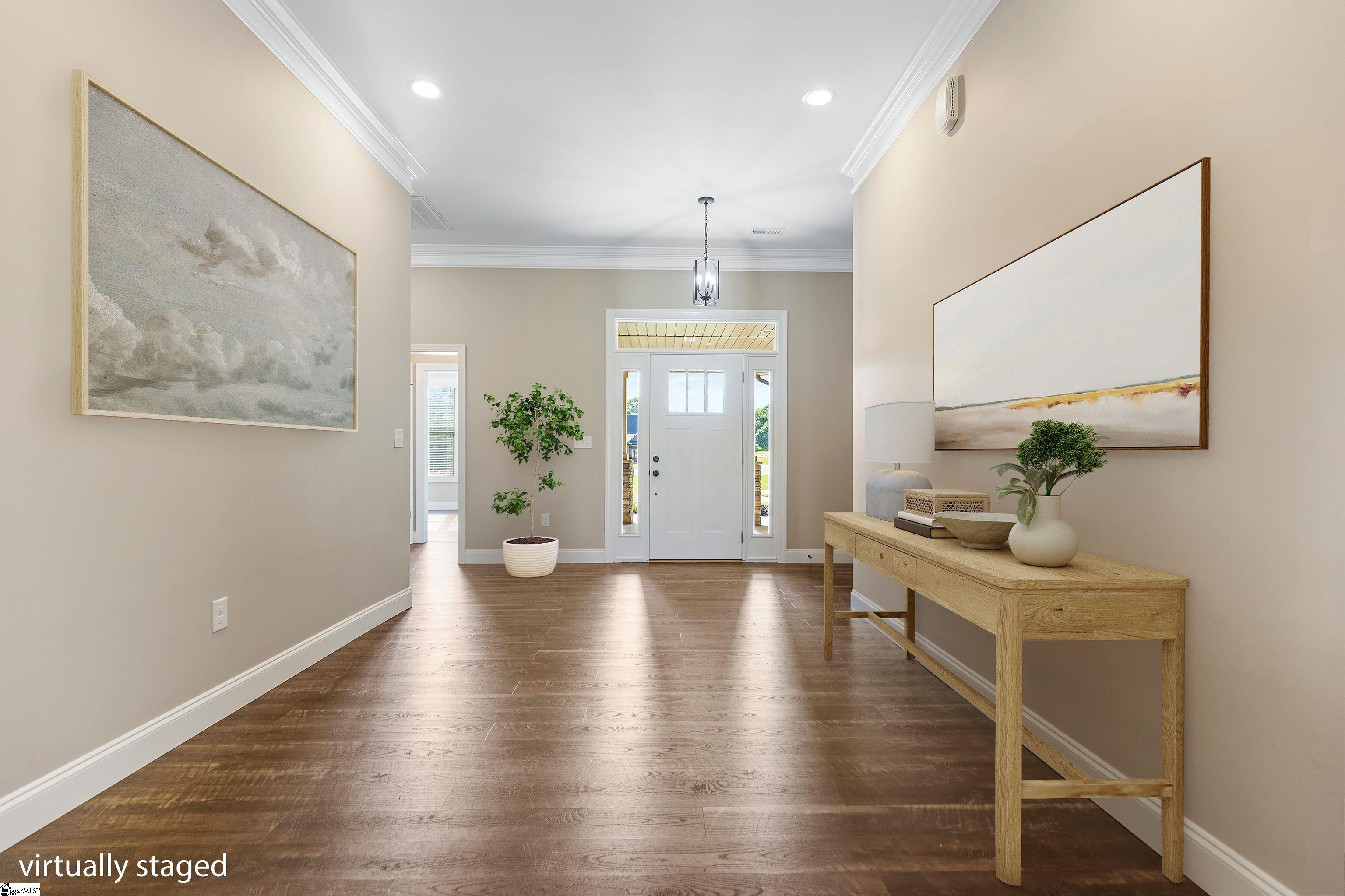 Welcoming foyer with a clear view of the elegant front door, showcasing natural light, stylish flooring, and a warm first impression.