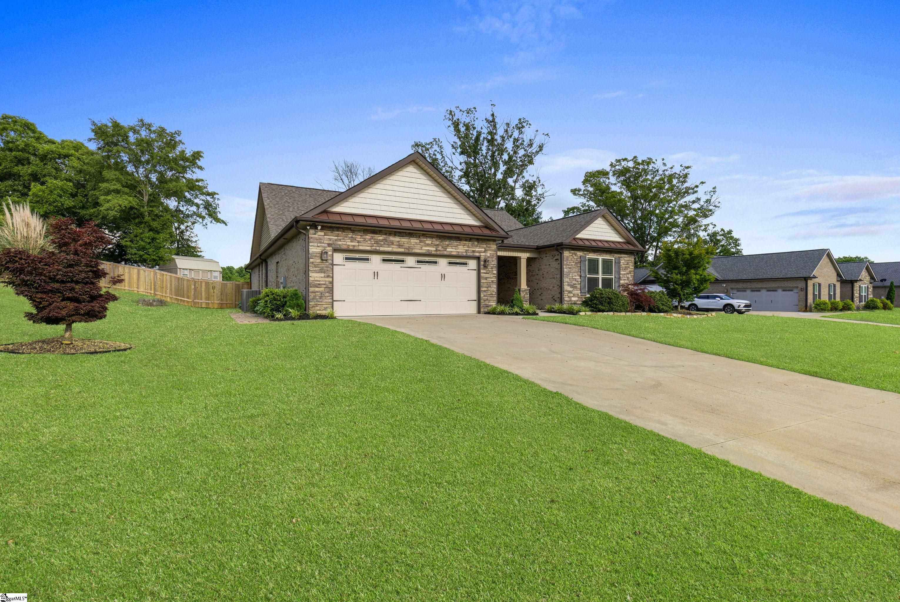 Charming curb appeal with manicured landscaping and welcoming front entry.