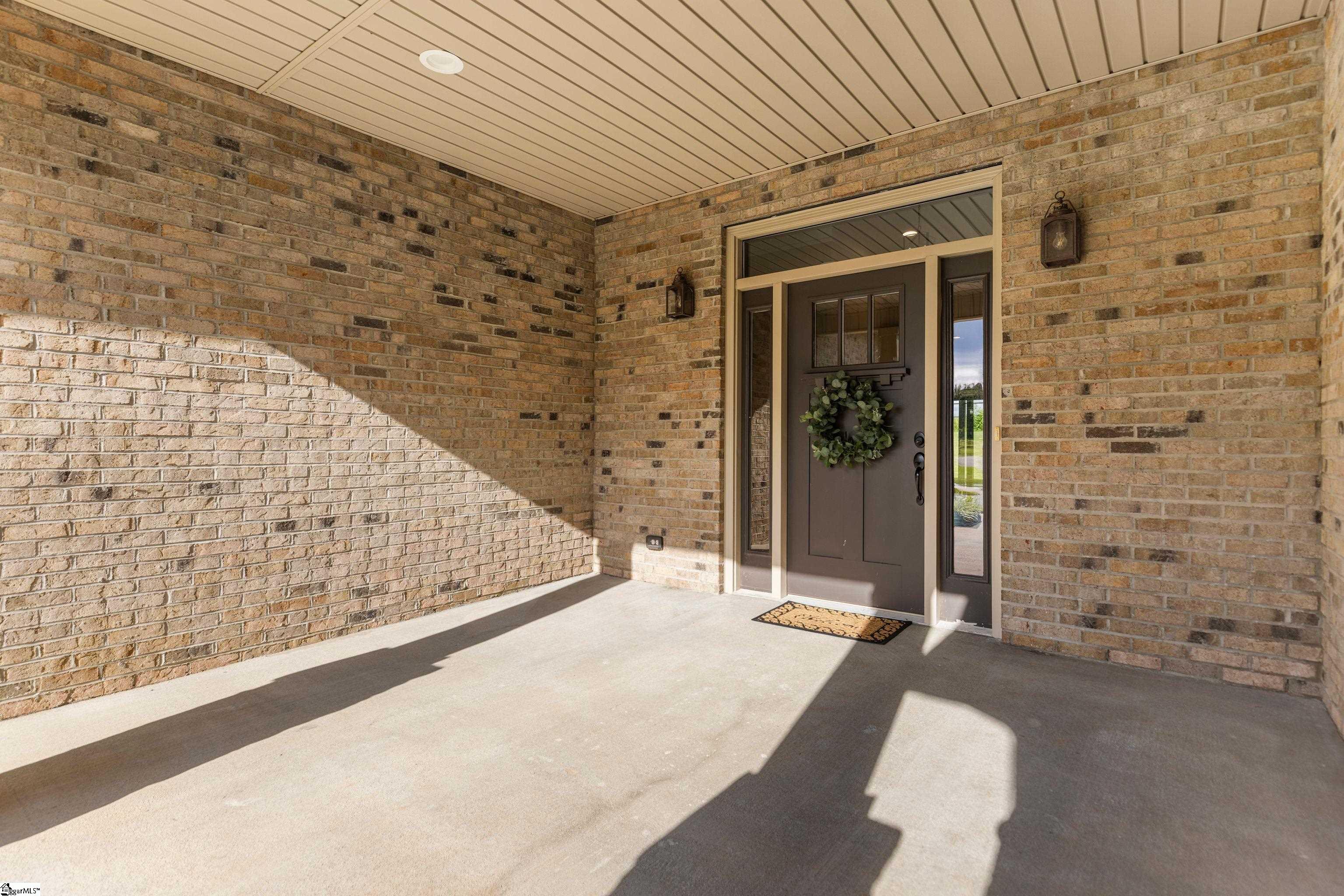 Spacious covered front entry—perfect for relaxing with morning coffee or evening chats