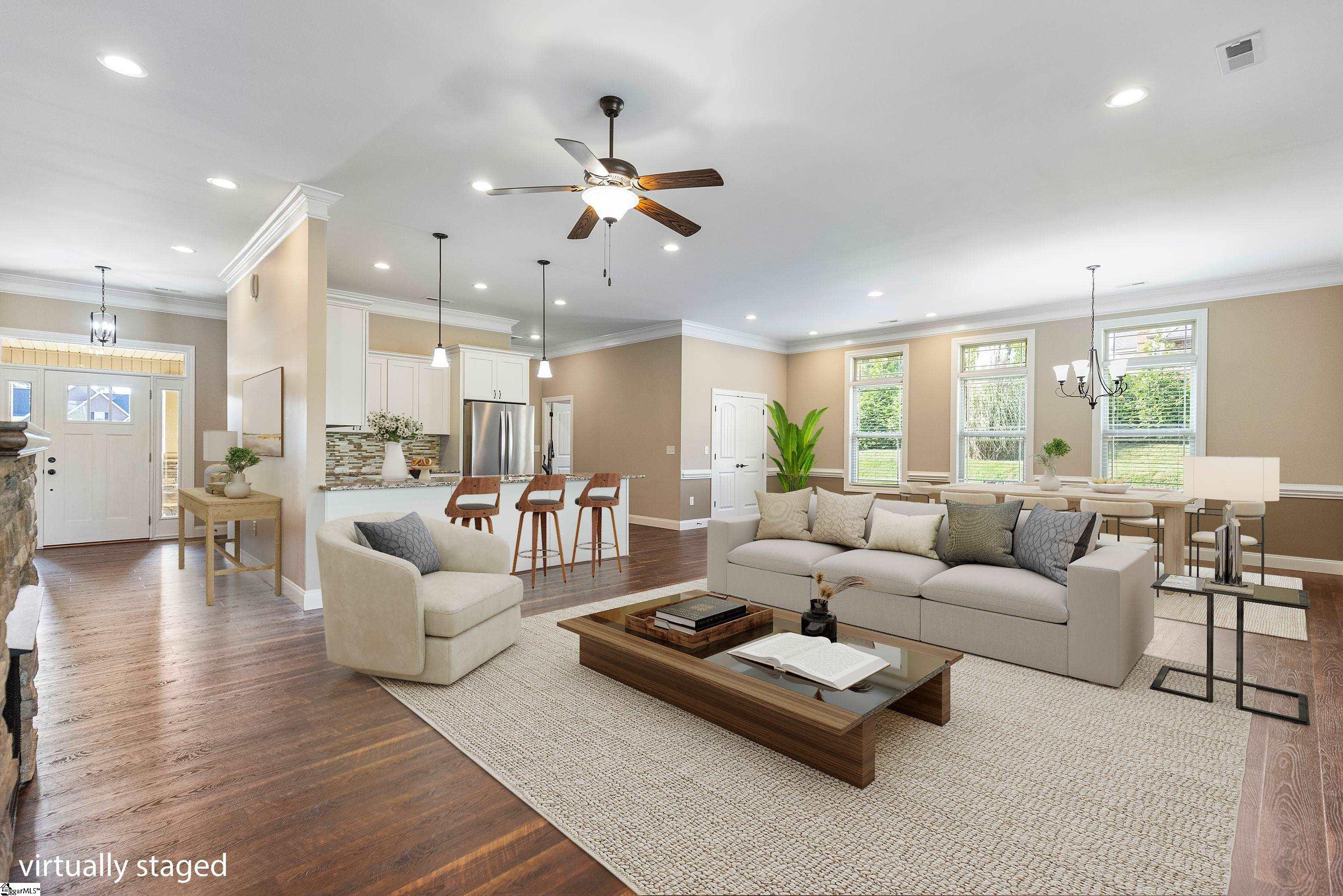 Spacious Great Room with fireplace and access to outdoor living space.
