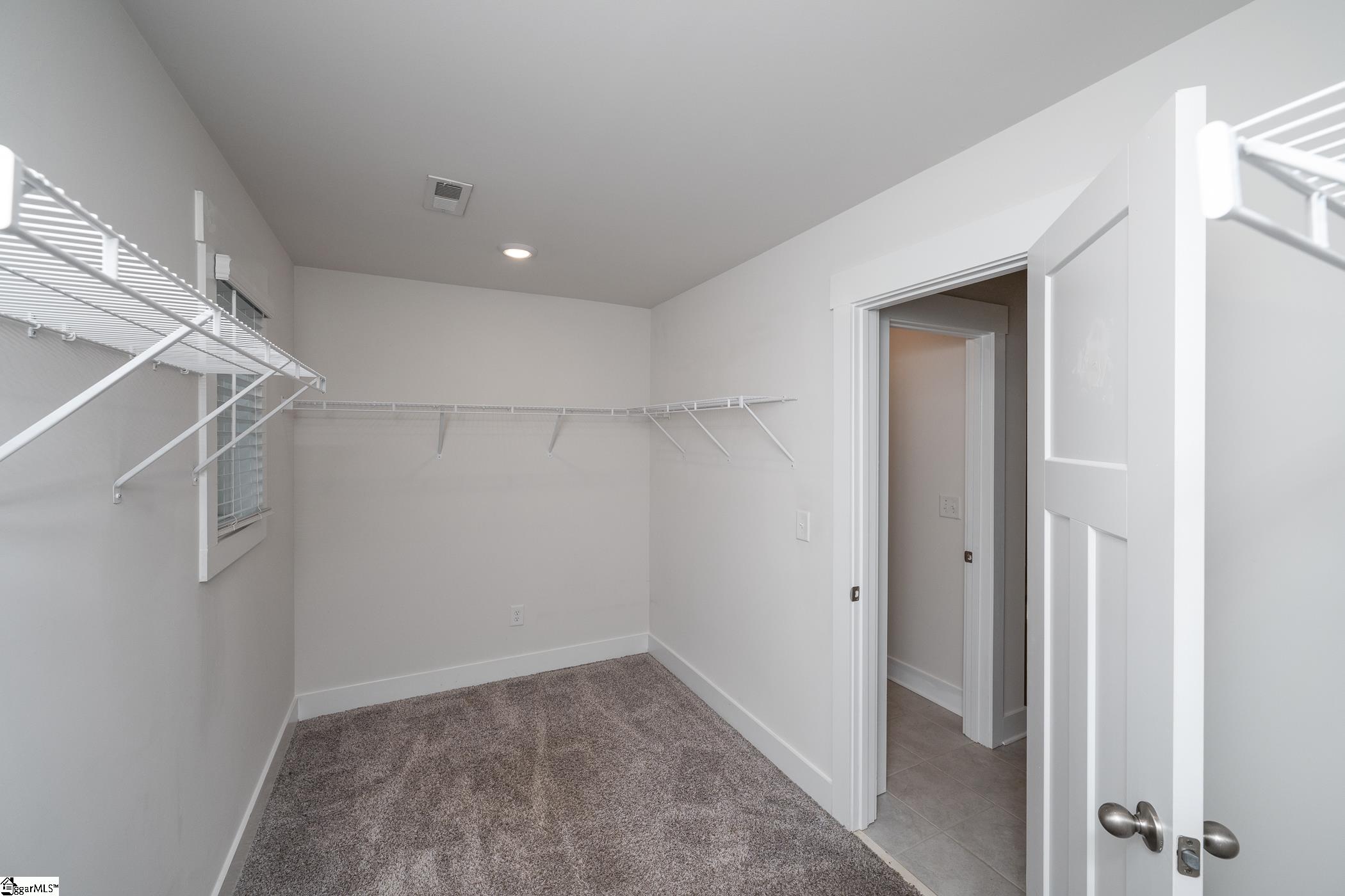 Huge walk in closet that leads to laundry room.
