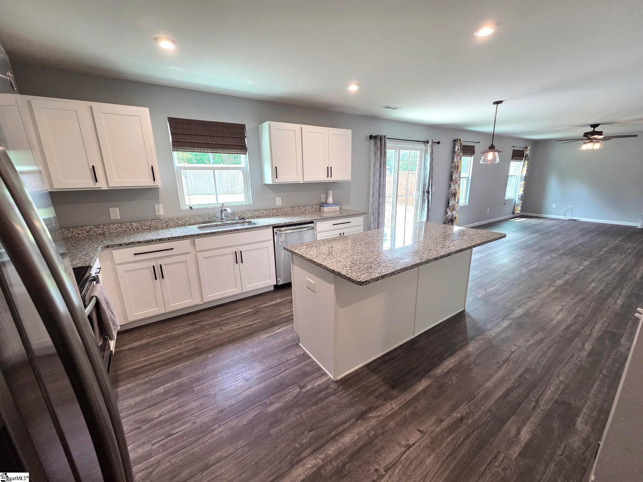 Kitchen area walking in from garage door near desk / office nook.