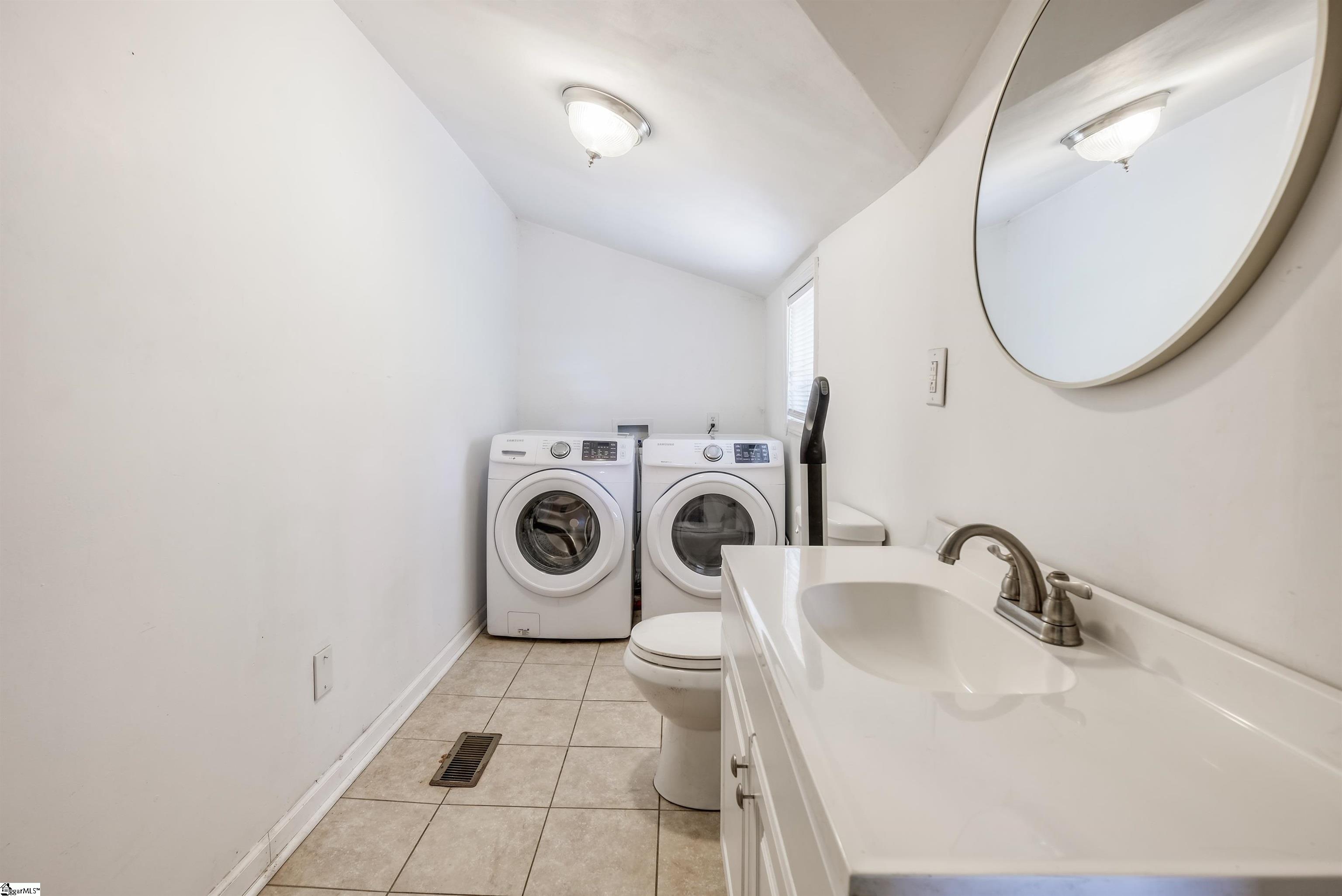 Combination 1/2 bathroom with washer and dryer.