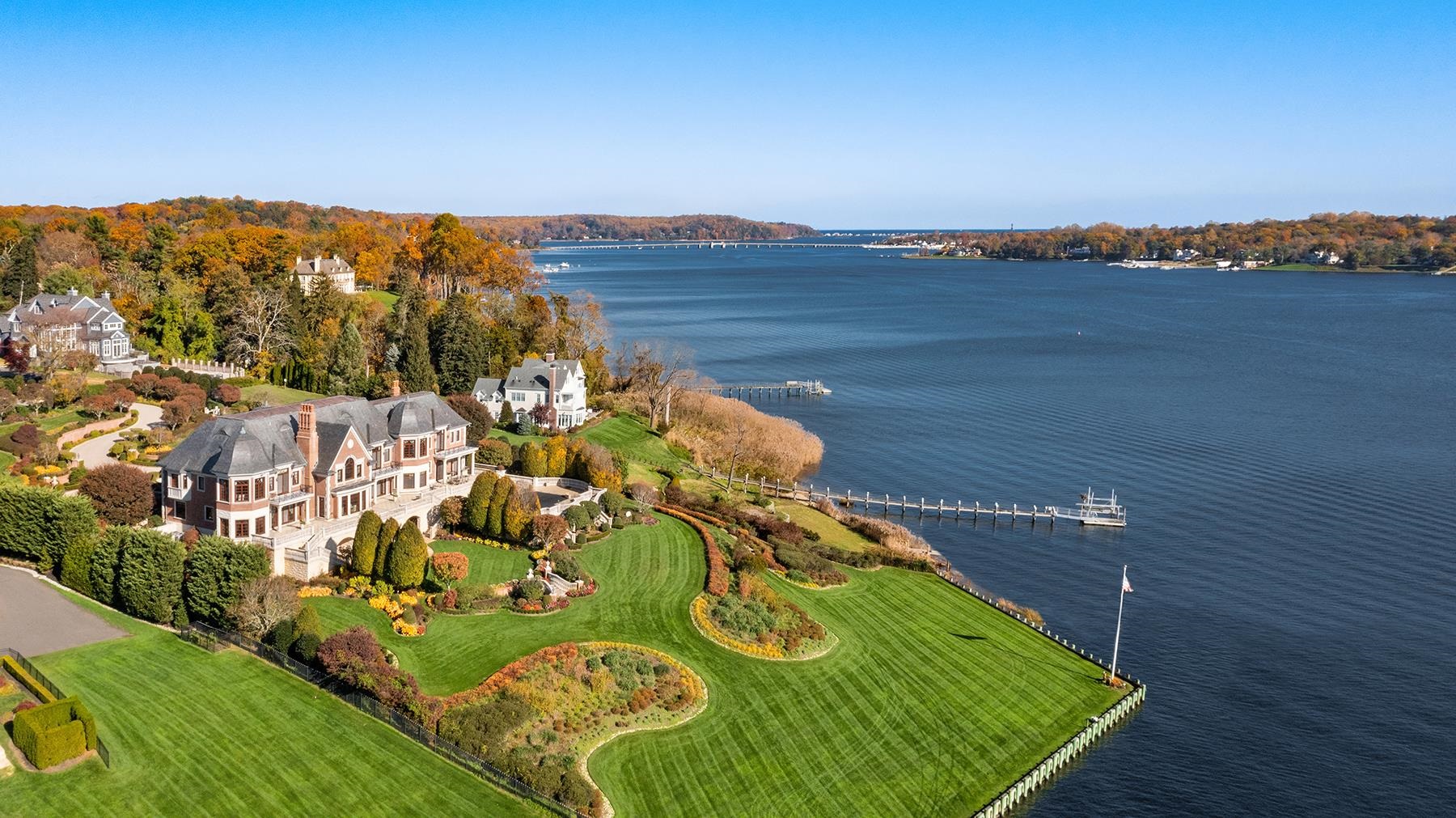 This elite, waterfront chateau, custom-built with the finest materials and bespoke craftsmanship, is unmatched by even the most respected homebuilders. From its unrivaled position on the banks of the picturesque Navesink River, this lushly landscaped 3.5 acre property boasts over 300 feet of private shoreline complete with a 150-foot Brazilian hardwood dock and boat lift. Constructed from only the most premium of materials from an all slate roof to Stone Legends exterior trim and a poured-concrete foundation, the design elements of this extraordinary home are unparalleled. Tischler windows and exterior doors, solid mahogany hand-crafted millwork, radiant heated floors, elevator and smart home technology are just a few of the stunning features that puts this home in a league of its own.  This majestic home has a grand, yet unassumingly intimate feel. Optimally situated at the end of a prestigious cul-de-sac, the winding stone drive from the gated entry leads to a grand paver stone courtyard with four-car garage and porte cochere. Inside, nearly every room basks in southern exposure and riverfront views. Formal great room and expansive dining room lead to a world-class kitchen, breakfast room and inviting family room. A massive game room with billiards, wet bar and poker chamber opens to a stately home office. Above, a sprawling owner's wing lies adjacent to four additional bedroom suites and separate staff quarters. The 6,000+ square feet garden level, designed as a Parisian hideaway, includes a movie theatre, gym, indoor spa, sauna, a pub-style bar and wine cellar. Outside, rolling lawns, verandas, multi-level terraces and a luxurious pool complete the waterfront lifestyle. Located just under fifty miles outside of Manhattan, this distinguished estate is a short drive to ocean beaches, golf and beach clubs, airports, heliports, high-speed ferries and trains.