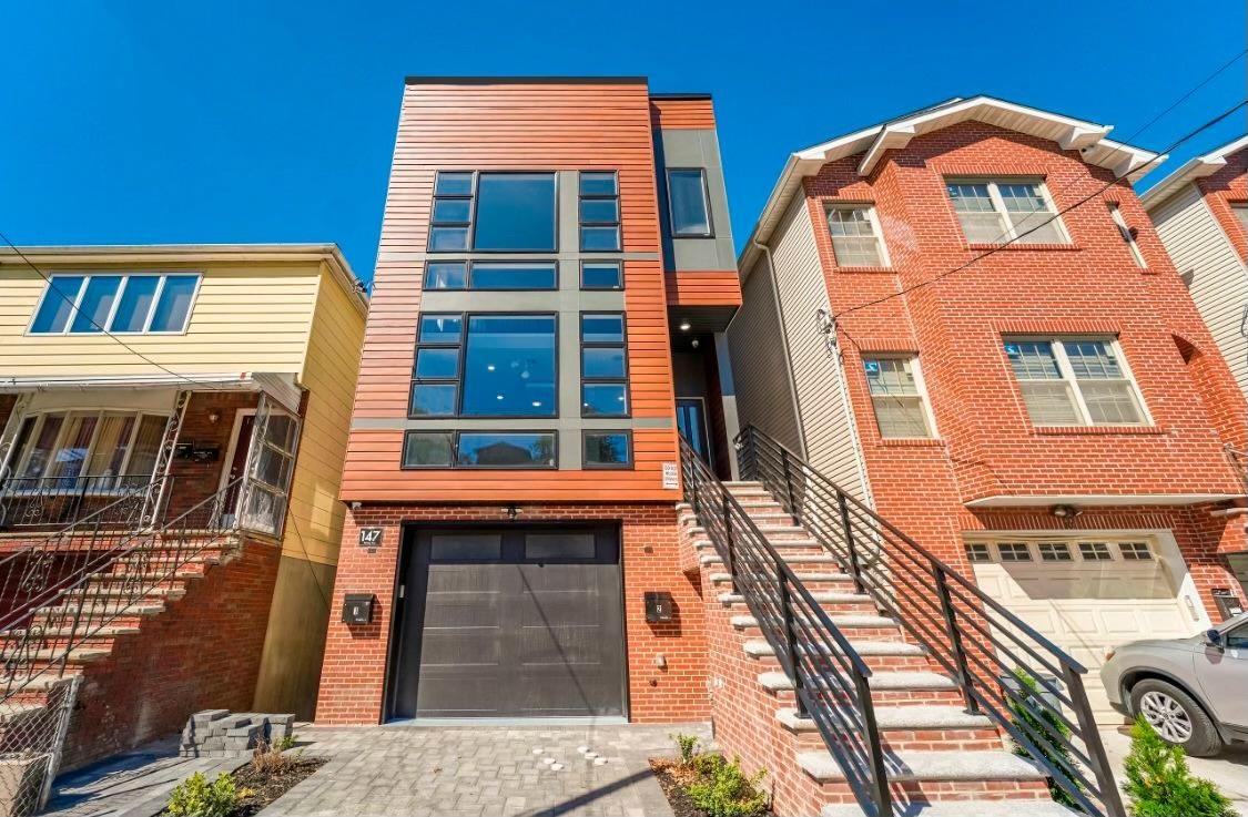 Brand new ONE OF A KIND LUXURY UNIT ! GN Management does it again , providing top of the line finishes and technology throughout this home! This triplex unit has all the features of a single family home including over 3,200 SQUARE FEET (that's about twice the size of many new units in Jersey City Heights). This unit boasts 4 bedrooms (2 of which are master suites with walk-in closets) 5 perfectly designed bathrooms, HUGE exercise/media room, recreation room with wet bar, open concept living room / dining room with eat-in kitchen with large quartz waterfall island, faucet over stove, built in cabinet microwave, farmhouse sink, washer/dryer closet, 2 electrical fireplaces, 2 balconies, deck & backyard, and garage parking. Each bathroom was designed meticulously with high end finishes, modern vanities & lights. This is a tech-lovers dream, built in audio speakers , cable ready, security system, and nest thermostat. This home truly provides peace of mind when it comes to noise and energy efficiency, thanks to the extra-thick soundproofing and great quality insulation. The developer truly went above & beyond with modern design, quality of material, number of bedrooms and bathrooms, and custom carpentry/trim. Transportation is very accessible making it an easy commute to NYC PORT AUTHORITY, JSQ PATH, Downtown JC and Hoboken. Also conveniently located near parks and schools. Developer is offering a 10 Year new home warranty! Eligible for a 5 year TAX ABATEMENT. Take advantage of the opportunity to purchase this unique one of a kind unit ! Unit has 1 car tandem garage spot.