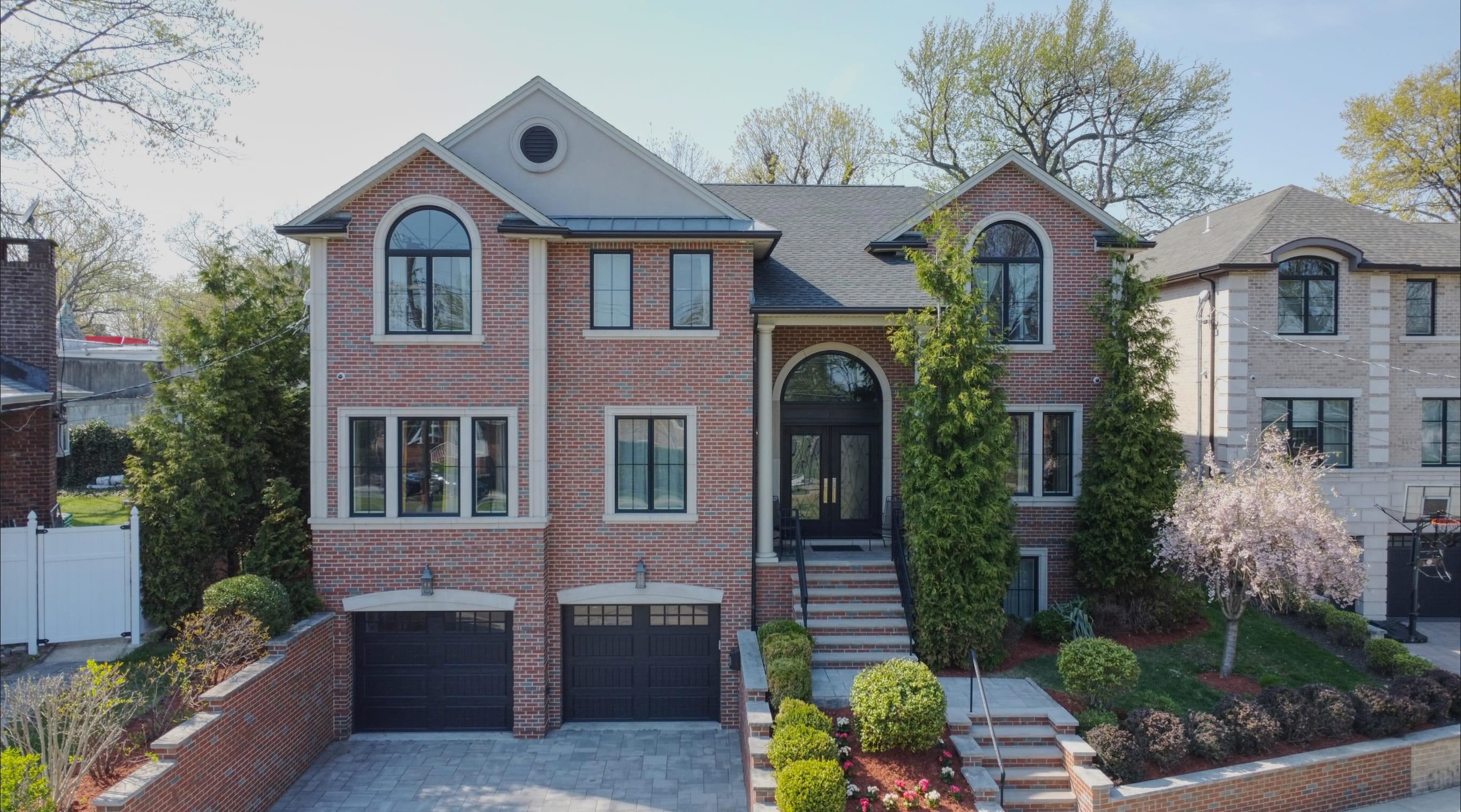 A Rare Opportunity to Own on Fort Lee's Most Iconic Boulevard Welcome to 1295 Abbott Boulevardan address synonymous with prestige, privacy, and timeless sophistication. This east-facing, newer 5-bedroom, 4.5-bath custom colonial is nestled along one of Fort Lee's most celebrated residential corridors. Just minutes from Manhattan, top-rated schools, scenic parks, and the area's best dining and shopping, this home offers an extraordinary lifestyle for those who value elegance and convenience. From the moment you step into the grand double-height foyer, you're surrounded by a sense of scale, craftsmanship, and refinement. A sweeping staircase and soaring ceilings make a stunning first impression, while warm designer finishes throughout lend a welcoming, contemporary feel. At the heart of the home lies a state-of-the-art chef's kitchen featuring Thermador appliances, a double oven, quartzite countertops, a dramatic 6-inch marble waterfall island, a self-opening refrigerator, a wine fridge, and a dishwasher. The space flows effortlessly into a generous family room with a custom gas fireplace and built-in shelvingideal for intimate evenings or upscale entertaining. Also on the main level is a splendid private office overlooking the garden, offering a peaceful, sunlit space to work or unwind. Upstairs, the primary suite is a private sanctuary, complete with a cozy fireplace, dual walk-in closets, and a spa-inspired bathroom featuring radiant heated floors, a soaking tub, double vanities, and a glass-enclosed rainfall shower. The home includes five en-suite bedrooms, each with a full bathincluding a thoughtfully designed Jack-and-Jill setup shared between two bedrooms, providing privacy and efficiency without sacrificing luxury. Enjoy morning sunlight from the home's elegant east-facing front, and peaceful sunsets in the serene, landscaped backyardperfect for quiet relaxation or outdoor gatherings. The fully finished lower level expands your options with a spacious recreation room, full bath, and additional bedroomideal for guests, a fitness space, or media room. Notable amenities include a 3-zone forced-air HVAC system, a heated 3-car garage with tandem space, a beautifully finished paver driveway and patio, and a fully integrated alarm and intercom system for security and convenience. This is more than a homeit's an invitation to own a landmark property on one of Fort Lee's most prestigious boulevards, where timeless design meets modern luxury. Private showings available by appointment.