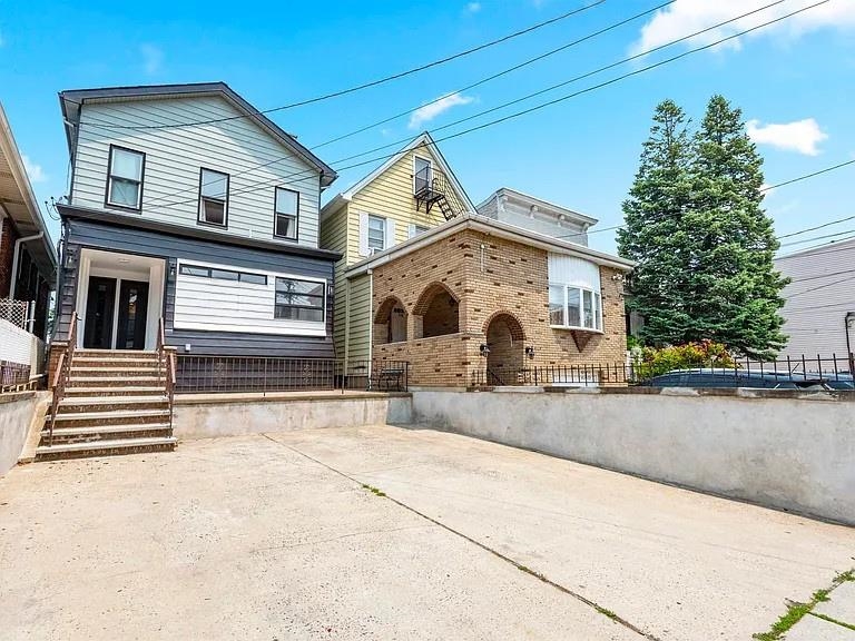 Turnkey two-family home just minutes from Midtown NYC. Both units vacant. Unit 1 boasts an open layout, chef's kitchen, exposed brick, spa-like bath, and floor-to-ceiling glass doors opening to a private backyard. The finished basement adds extra space and full laundry. Unit 2 offers 3 bedrooms, a full bath, hardwood floors, and a private entryperfect for rental income or extended family. Both units previously rented for a combined $6, 300/month. Includes 4-car parking, newer roof, updated systems, and convenient NYC transit access.