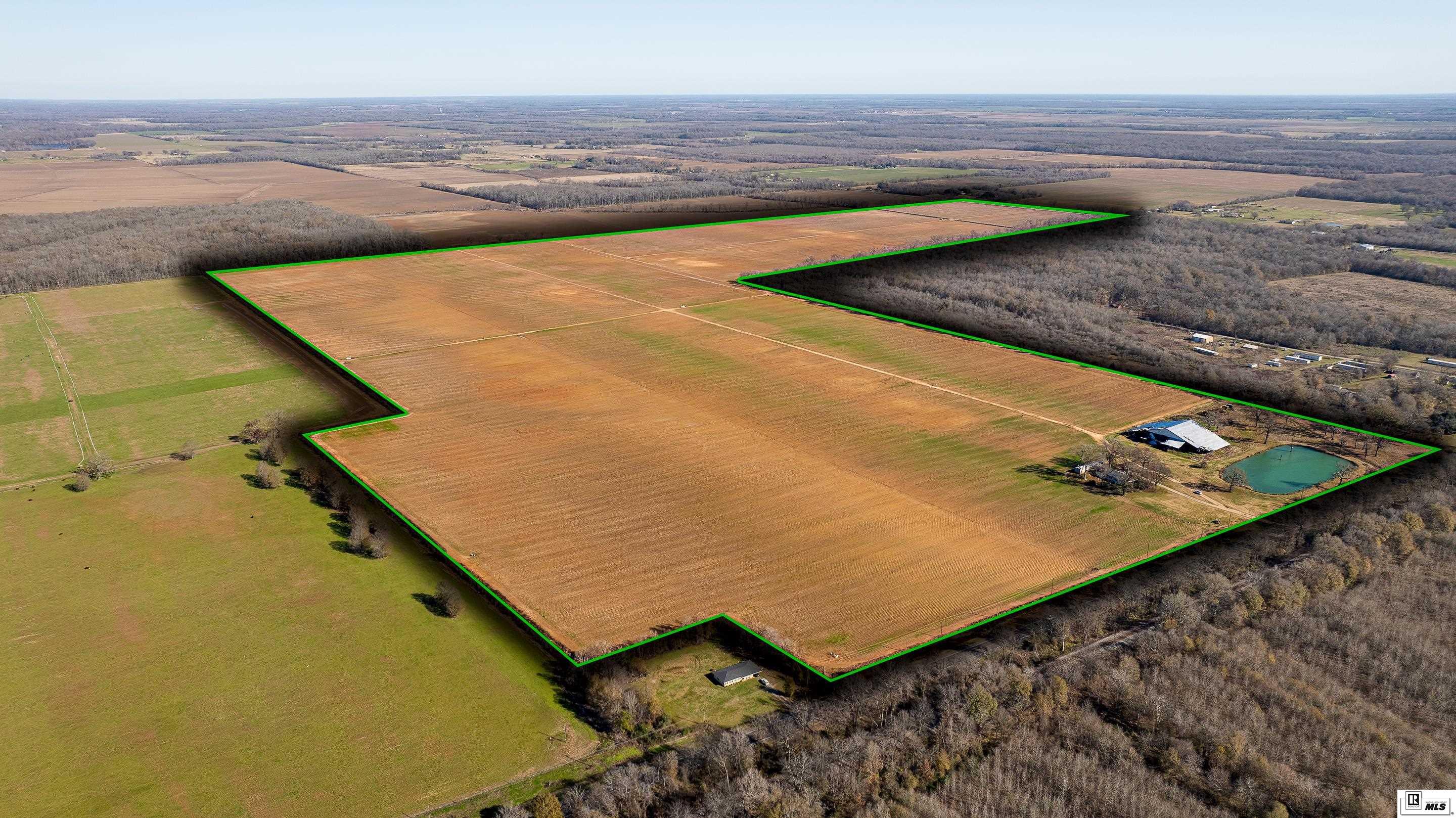 Large undeveloped site only 3.5 Miles from future Meta AI center in Holly Ridge Louisiana. This parcel is included in the Federal Opportunity Zone. This 300+- acre site is located 3.6+- miles West of the future Meta Development on Hwy. 80 in Richland Parish. The site is approximately 1.8+- miles from I20 via the Bee Bayou Exit 141 and 2.2 miles from Rayville Louisiana. The site is cleared, and precision leveled and is currently being used for row crop production. The property has 1,800' of road frontage on state hwy. 80 and 1,300' on Hwy. 583. The site has 3 phase electricity along Hwy. 80 and water from Boeuf River water system, no sewage. Improvements include one three-bedroom two bath site-built home, one single wide mobile home, one large barn in need of repair or demolition, 4 irrigation wells and a stock pond. The elevations range from 77' to 81' no Topo has currently been done on the property. The owners are in the process of discussing improvements to culverts which go under Hwy. 80 and restrict drainage to the West portion of the site with the DOTD. All acreage, elevations and road frontage are estimates obtained from Google Earth and will need to be verified by buyer through land and topo surveys. See aerial map and soil survey map attached. Please call the listing agents for all showings.  ________________________________________