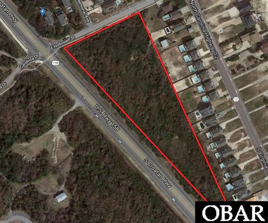 RARE OPPORTUNITY FOR 4.7 ACS AT A STOPLIGHT ON THE BYPASS. A vacant  commercial site of this size is very very unusual on the Outer Banks. Centrally located across from Jockeys Ridge State Park(annual visitation of 1.5 million, highest state park on the Outer Banks), this site lends itself to many usages, with extensive road frontage and direct ocean access. Discerning investors will not find a more visible, and accessible site on the Outer Banks.