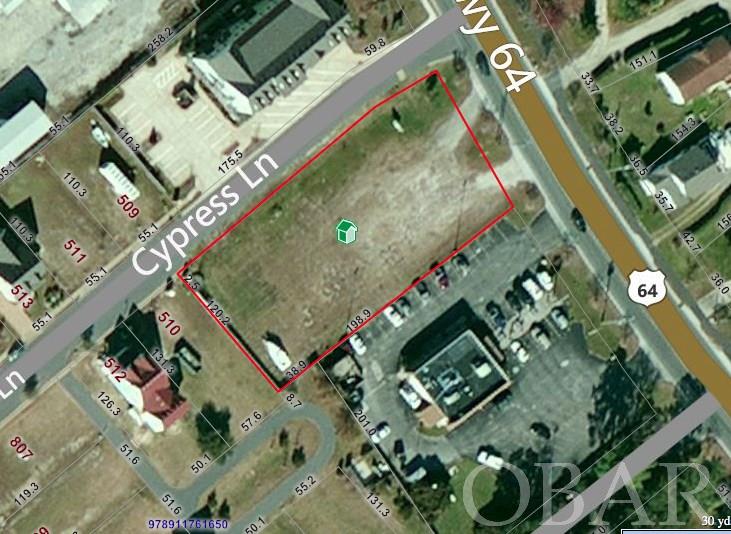 Great opportunity for business development.  This .72 acre lot fronts Hwy 64/264 and is located only minutes from the downtown Manteo waterfront in one direction and is south of main highway 64 and the Dare County courthouse and complex.  Zoned commercial, this parcel's corner location borders the Cypress Cove community and is parallel to the established commercial businesses across the private street.  This raw land parcel borders the main road and offers municipal water and sewer.