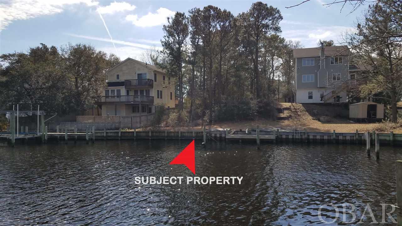 Build your own OBX home on this canalfront home site, and enjoy relaxing, boating, kayaking on the water every day.  Colington Harbour has so much to offer with deep water canals, clubhouse, boat ramp, soundfront beach area with playground for grilling.  Optional pool membership for homeowners.  Check out this gated community when deciding where to settle in the Outer Banks!