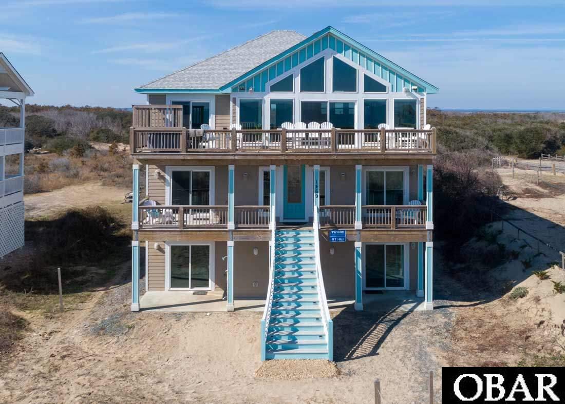 A truly remarkable custom built luxury oceanfront home for which no expense has been spared during design, construction, or furnishing. Home is less than 2 miles up the beach from the paved road, close to amenities of town, within the highly coveted pristine area of 4x4 beaches. House has amazing views from top two floors of both the sound and ocean, where you can start the day with the sunrise and end the day with amazing sunset views. You must see this one of a kind home to really appreciate all of its amenities. With views from nearly every room on all floors, this home comes equipped with all the latest technology that one would expect elsewhere. Fully automated Roller shades on top floor in sync with Alexa. 11 audio zones inside and out, for a seamless transition from indoor living to outdoor. Outdoor dining on ground floor covered porch area with TV off 12 foot sliding glass doors that open to rec room. Game room with wet bar, ice maker, 3 TV's, full size pool table,  and surround sound. 12 seat theater with stadium seats on tiers make this a full cinematic experience.  Various lighting in house can be controlled by operator via Phillips Hue app. Two Hot tubs, one on top floor East facing deck with panoramic ocean views, and other in pool area. A custom kitchen with Alexa integrated applianes and backlit tile along 3 walls, make this space truly unique. Beautifully designed tiered pool area with tanning ledge that waterfalls into 12x28 freeform pool. Lovely custom stonework on face of tanning ledge and steps. Tiki bar and commercial outdoor grill with fridge and sink make this an entertainers dream. Built in propane firepit in corner of pool area is the perfect spot to sit and enjoy a cocktail after a day at the beach. This spectacular house sits atop nearly 1.5 acres of oceanfront heaven with many private areas, inside and out, to enjoy your time at the beach. Three of the master suites have custom tile showers that you would expect to see in a 5 star hotel. Backlit mirrors in baths, lighting in many of the custom feature areas of the house highlight its amazing details. Ground floor has handicap accessible BD and Bath with roll in shower with grab bars. Elevator that truly is an experience to ride, with Outer Banks mural behind glass wall the entire ride up. The touches and details in this house are amazing, making it a one of a kind!