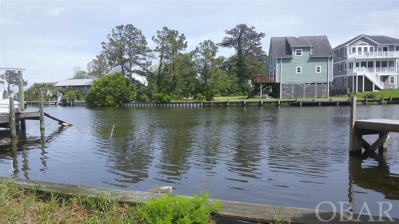 Canalfront with water views. Level building site with 22 feet of bulkhead in good condition; bulkhead only 6 years old. Take advantage of Colington Harbour ammenities.     Keep a small vessel or jet ski.   Great spot for an Airbnb. Equip house with a paddle boat or kayaks for the tenants to enjoy Kitty Hawk Bay and Colington Bay.