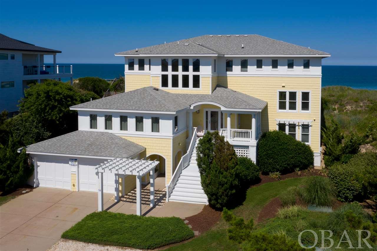 One of a kind opportunity in Whalehead! This beautiful home sits behind a nice oceanfront dune, on a large beautifully landscaped lot. Once featured in Coastal Living Magazine, it has all of the extras that make for a perfect vacation or second home. Enjoy a two car garage (so rare!), double laundry areas, elevator, game room, professional theater room with wide screen and snack bar, home workout space with cardio equipment, large outdoor heated pool (with 40 ft lap lane) area with fireplace, double outdoor showers, covered decks and a large open living area. Quality built by Olin Finch, this home has all of the attention to detail and craftsman features you can expect in a luxury property. Don't worry about beach access, you have your own private access right out back! Did I mention the views? Panoramic views from upstairs and mid level decks.