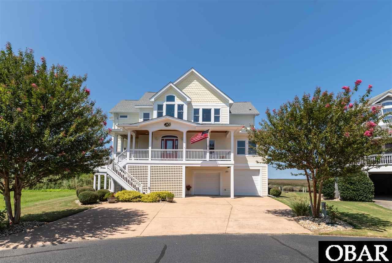 This home is located in one of the higher sections of Pirates Cove and has never flooded. Built in 2003 as a primary residence the home features a Reverse Floor Plan (with elevator access to all floors) and has a spectacular view of Shallowbag  Bay from the top floor Great Room and Breakfast Nook.  Access to the large top deck is off the Great Room where you have a front row seat to summer sunsets and July 4th fireworks.  The kitchen features all stainless appliances, a 6 burner Thermador Gas Cook top with Thermador down draft exhaust vent.  The spacious Great Room has vaulted ceilings, a gas fireplace and built-in display shelving.   The large Dinning Area is part of the Great Room.  The master Bedroom features a roomy walk closet and a second Hanging Closet with built in storage unit. Enjoy an oversize Master bath that has a walk in “Roman Style” shower, "Jacuzzi" style tub, double sinks and storage cabinet. The middle floor has a second Master with en-suite bathroom.  In addition the middle floor also has a large Sitting Room with wet bar. The Sitting Room’s sliding glass door gives access to the large screened rear deck that faces Shaollowbag Bay.  Also on the middle floor are the laundry room, 2 additional bedrooms, a shared full bath, a bonus room and office. The ground level has a full bath and room for a game room and shop area. The oversize garage is large enough for 3 cars plus a golf cart to be kept out of the weather.  There is an outside shower at the rear on the lower level patio area.  There are also two gas Rennai Instant Hot Water Heaters situated to service the home’s areas of high demand.  There is a hook-up on the second floor deck for a generator to service basic systems in the event of a power outage.  Both HVAC Units were replaced in 2018. There is 45 feet of assigned mooring directly behind the home ($130/yr. to PCHOA). In addition to the garage there is ample parking  for guests in front of home.