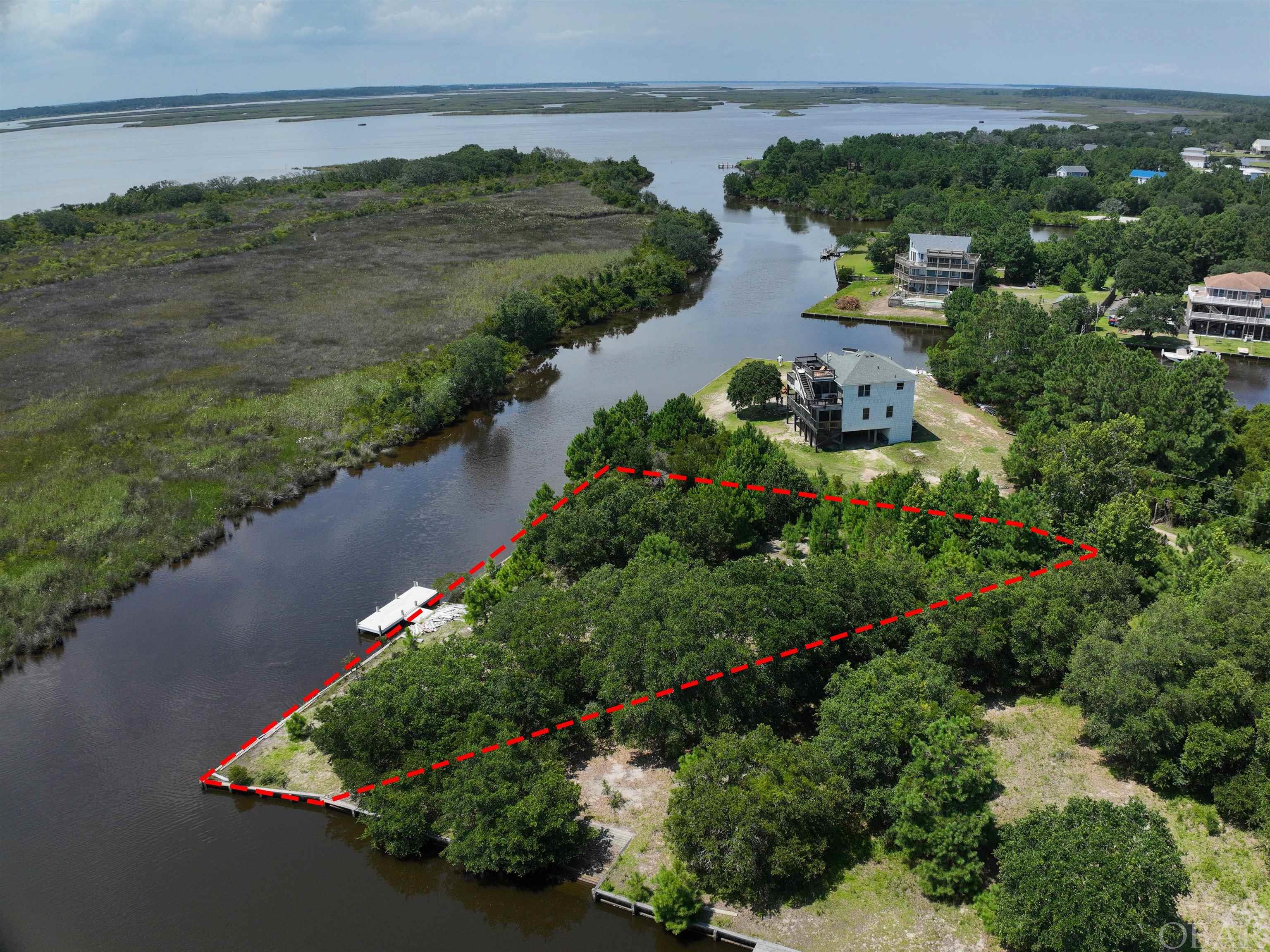 Looking for the ultimate waterfront retreat? Look no further! This rare and secluded over-sized lot is the perfect spot to build your dream home. Located at the end of a cul-de-sac and just steps away from the entrance to the sound, this lot offers wide open views across the water with nothing but federal land across the canal. Imagine enjoying the sound for the Corolla Wild Horses is your yard and the sun setting over the water in the evening. With its prime location and breathtaking views, this lot is truly one of a kind. Don't miss this amazing opportunity to own a piece of paradise - act now!