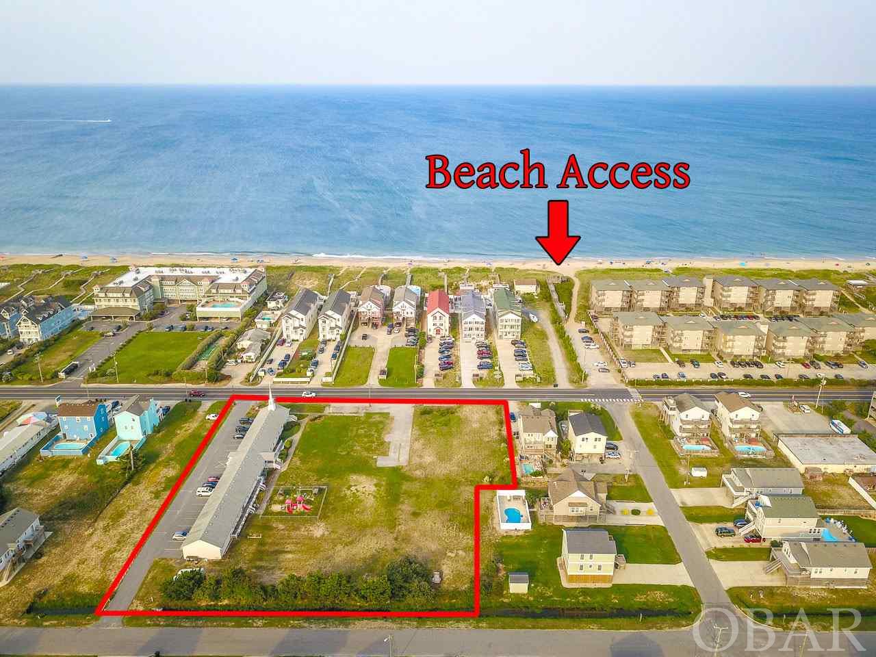 Large commercial semi oceanfront parcel offering Mixed Use possibilities. 1.98 acre lot in the heart of Kill Devil Hills. Prime location with 300' fronting Virginia Dare Trail (the Beach Rd/Route 12). Building on the property currently being used as a church. Access the beach at nearby Clark St. public access with parking. Convenient access to the 158 Bypass with a traffic light at Baum St. One of the largest semi oceanfront parcels available for development.